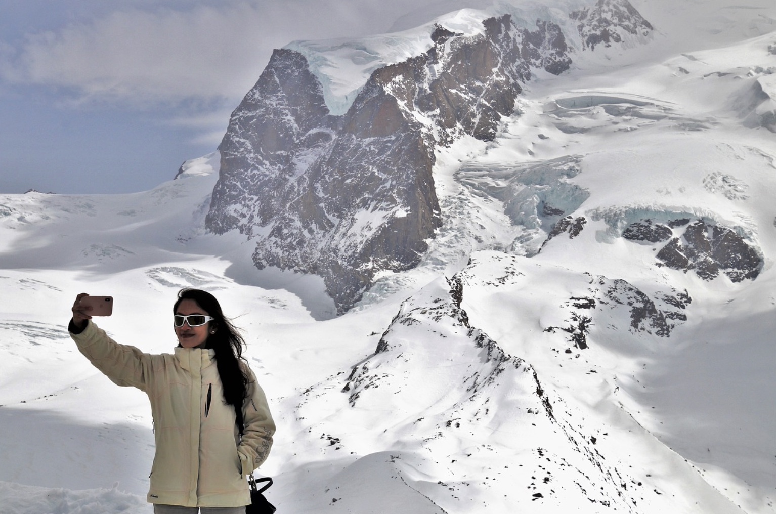 woman taking selfie snowy mountain