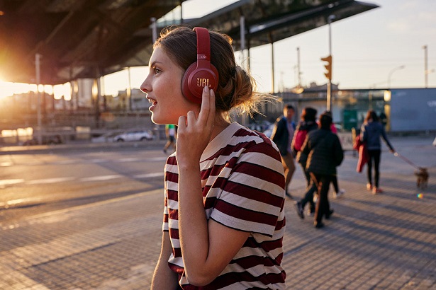 woman with red headphones at sunset
