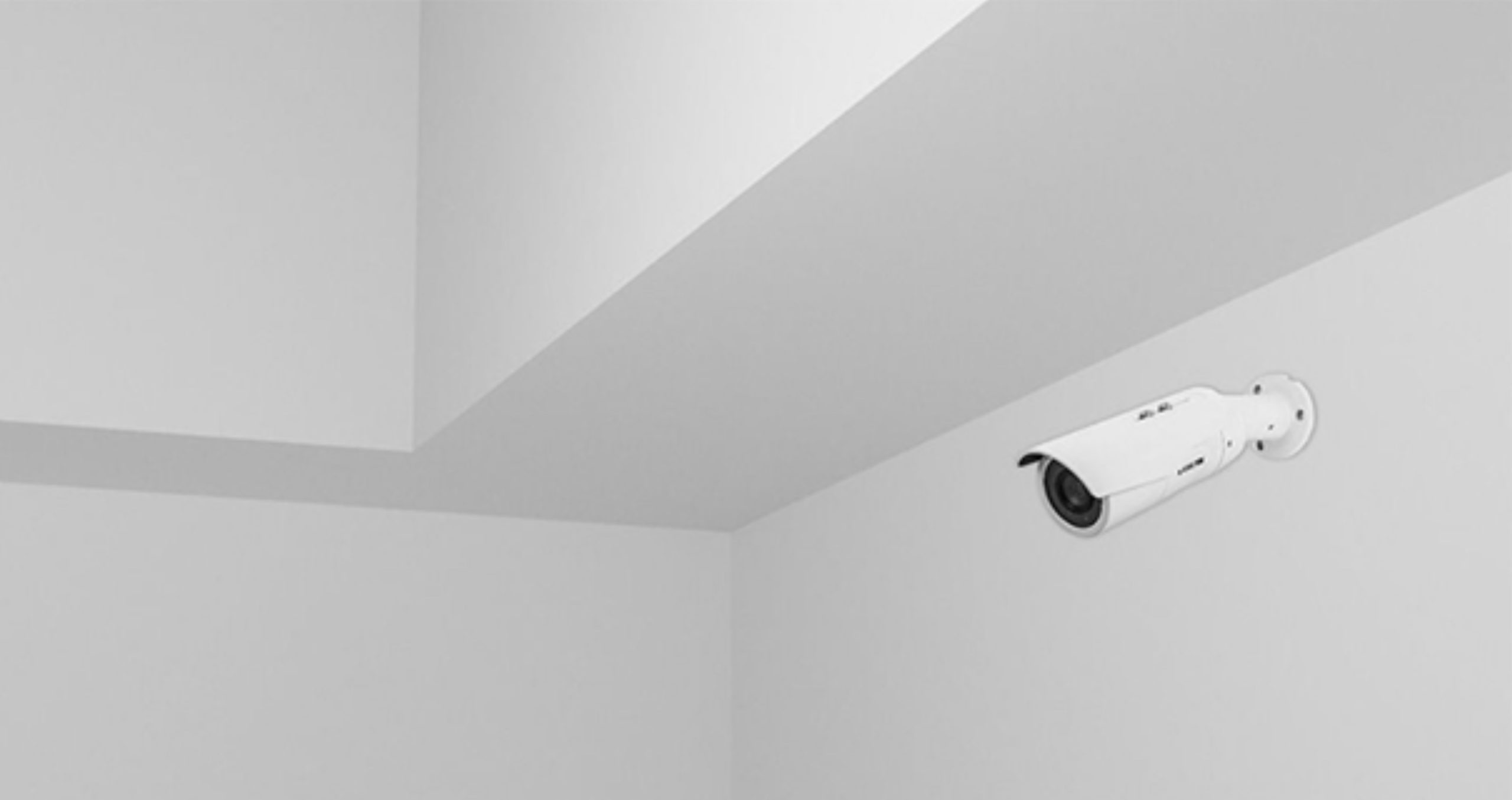 white security camera on wall