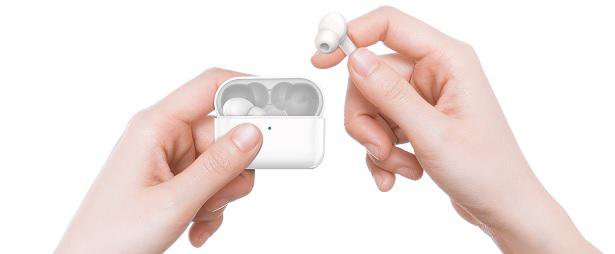 holding wireless earbuds