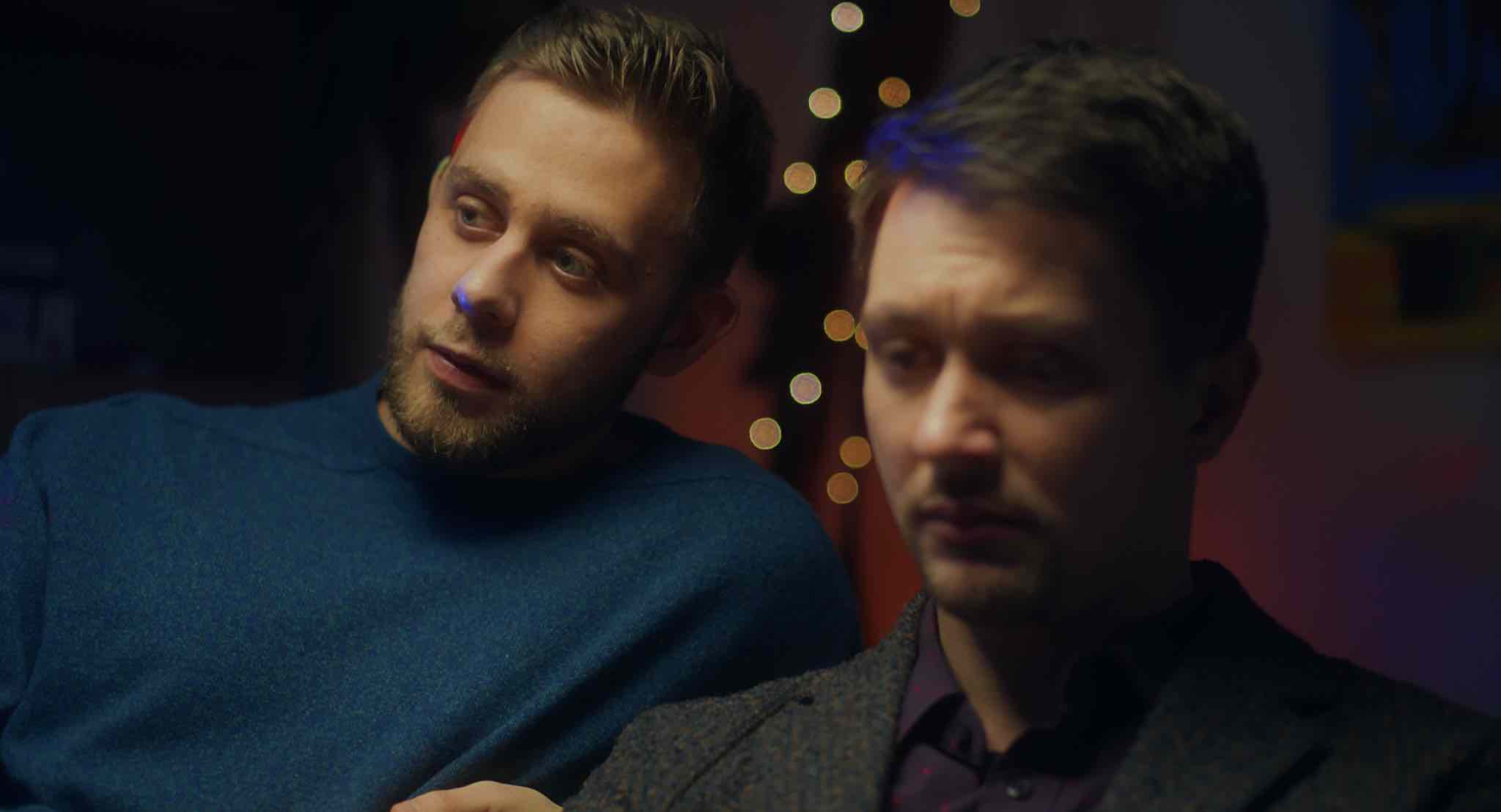 two men sitting together