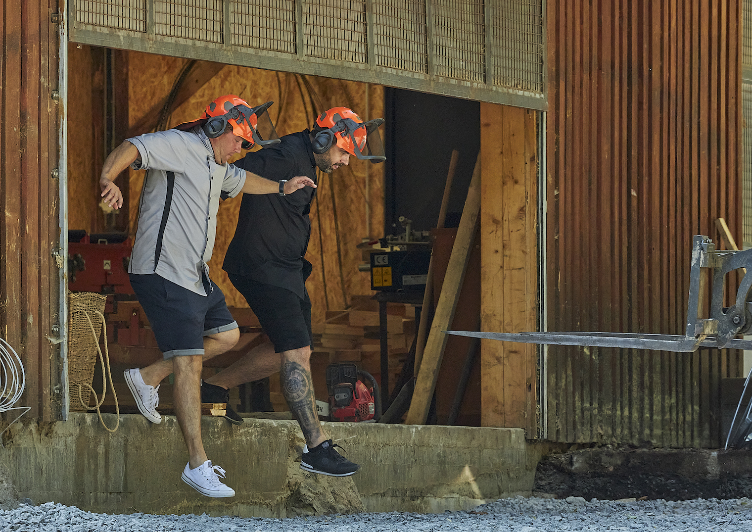 two men running out of barn