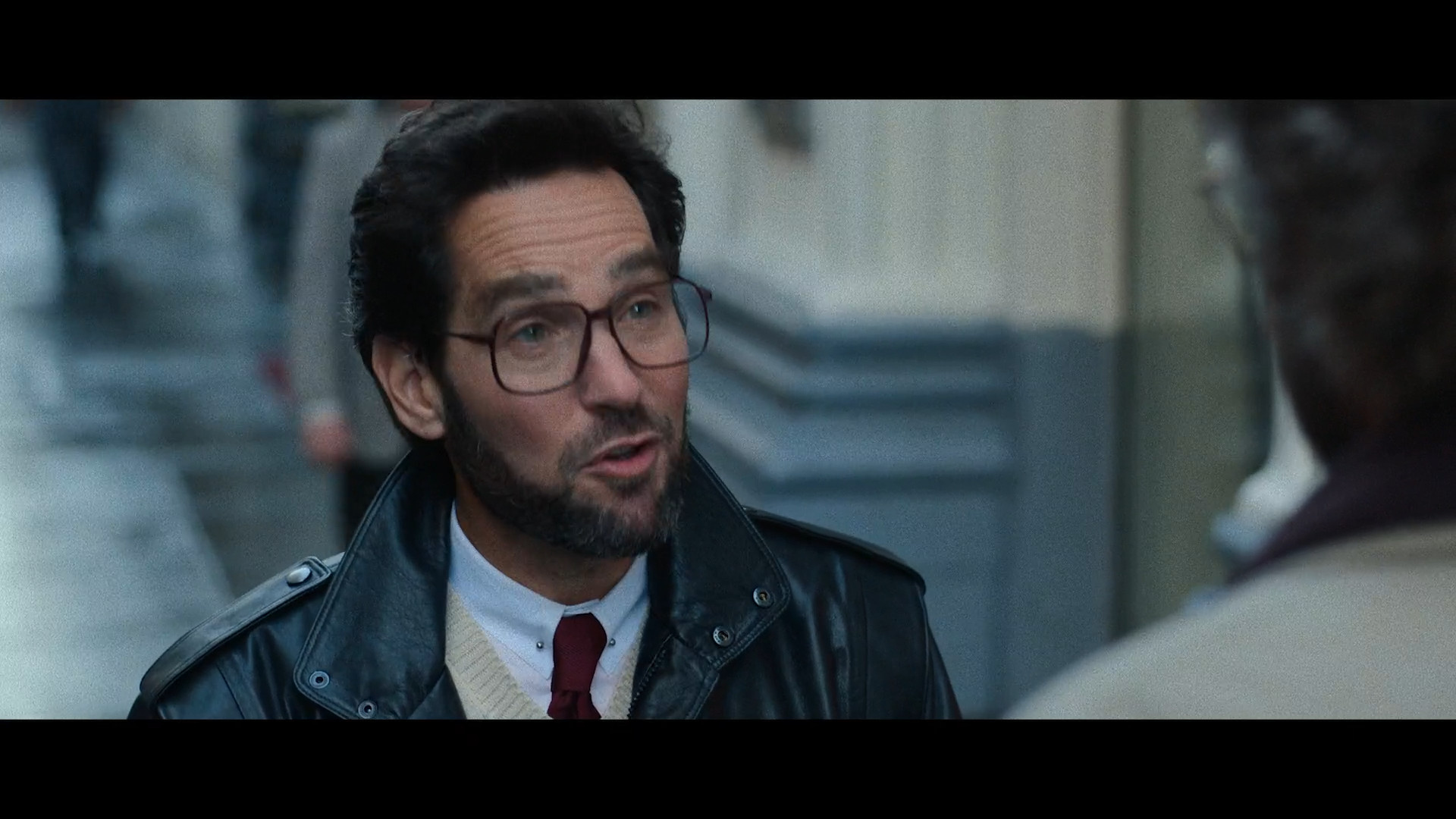 man in leather jacket talking