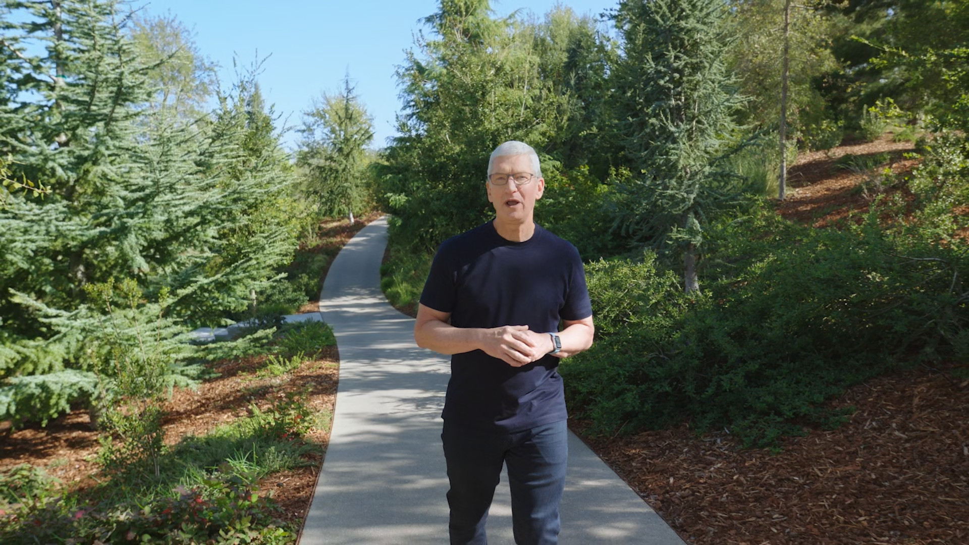 man speaking on forest path