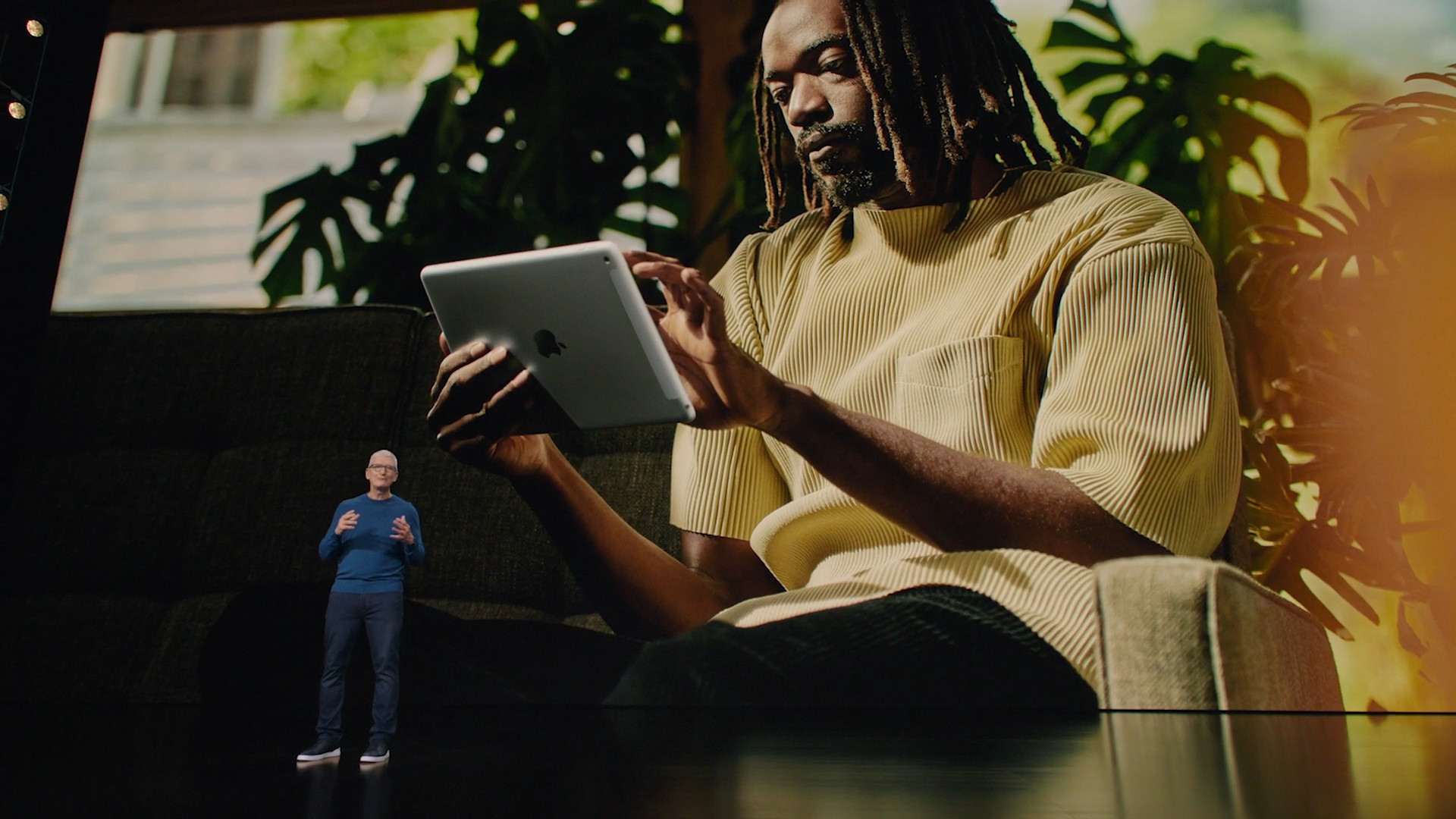 man using ipad on couch