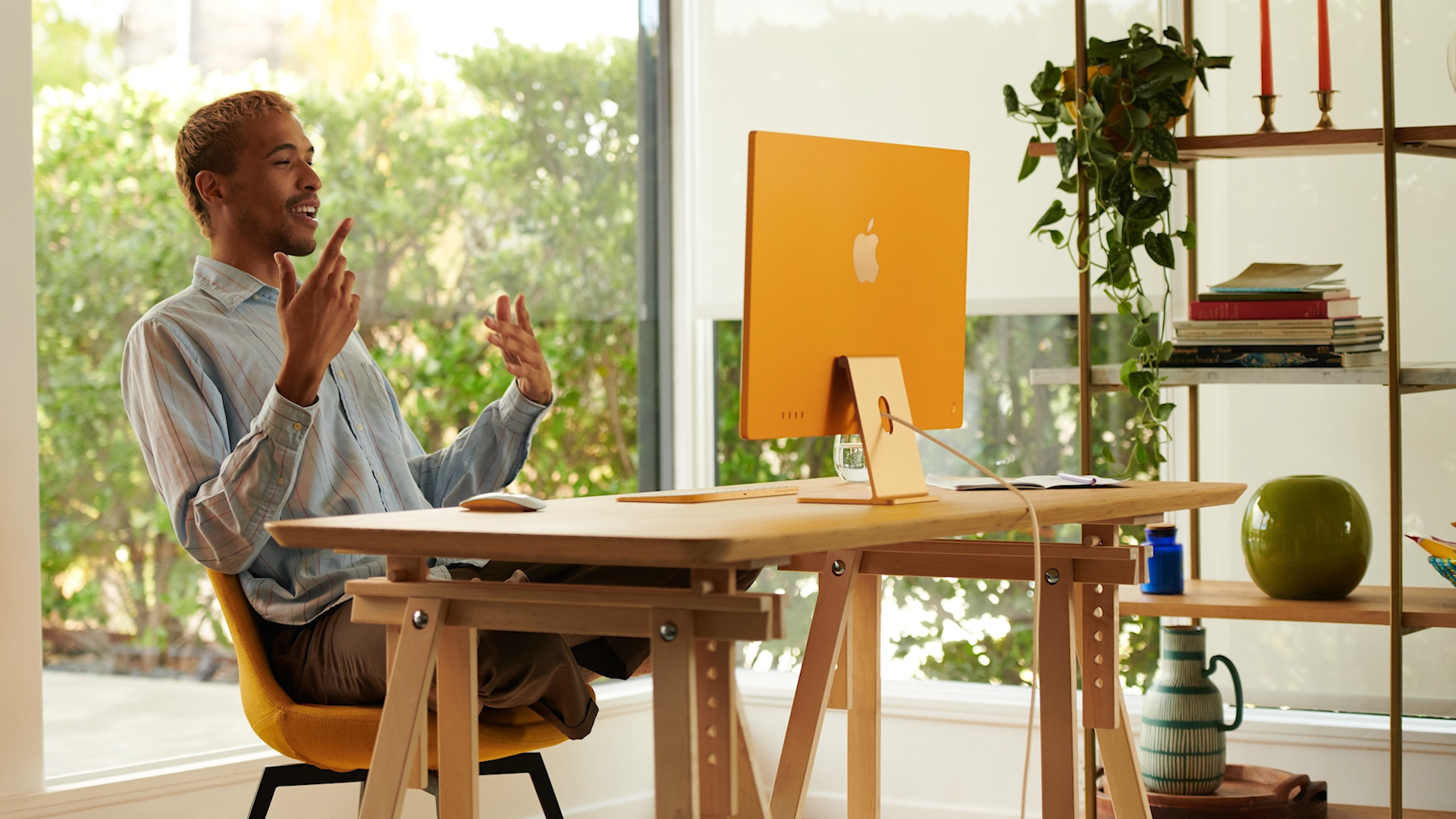 man working at desk with imac