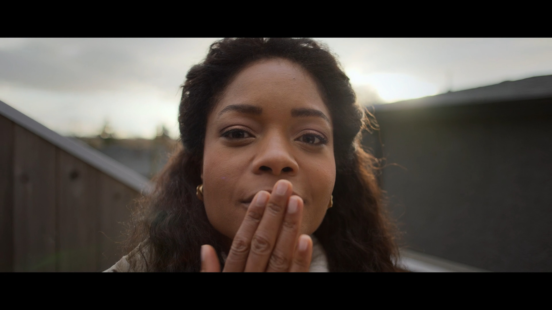 person blowing kiss outdoors
