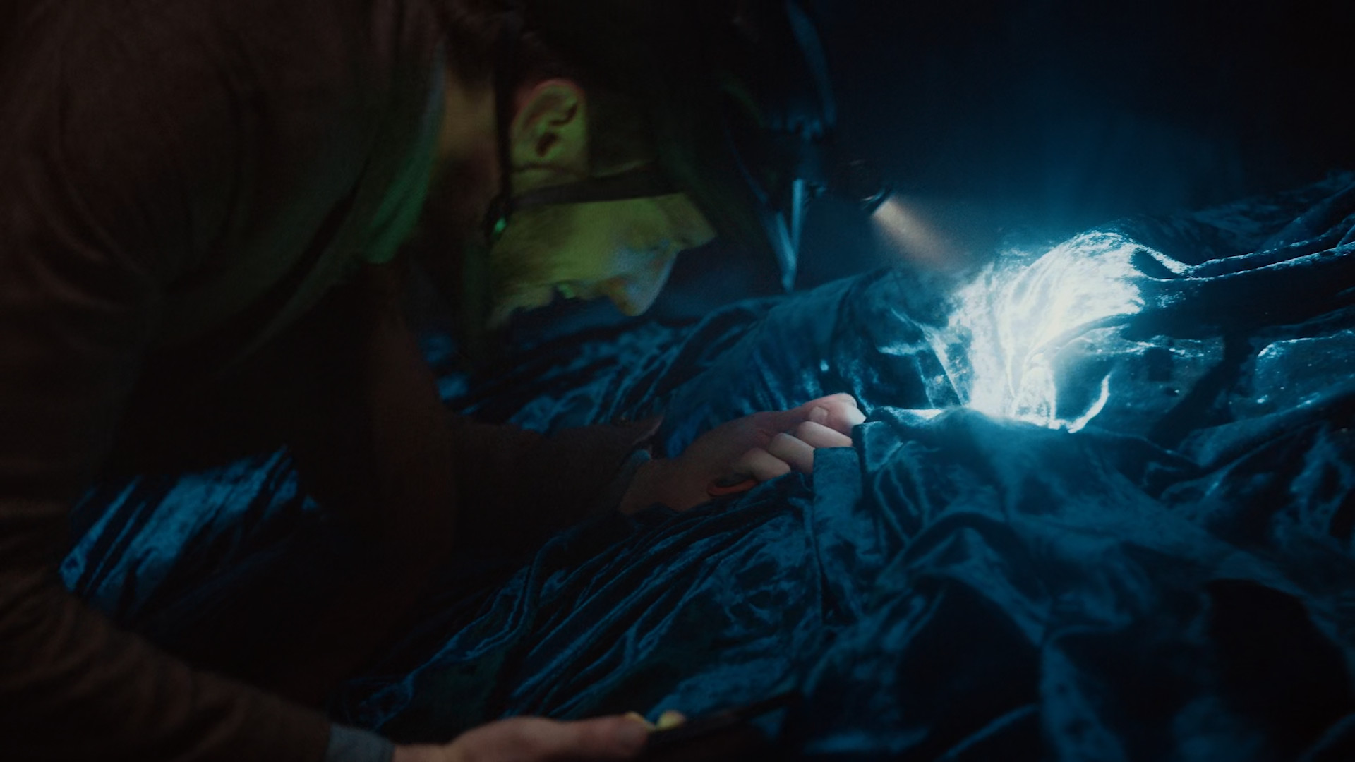 person exploring with headlamp