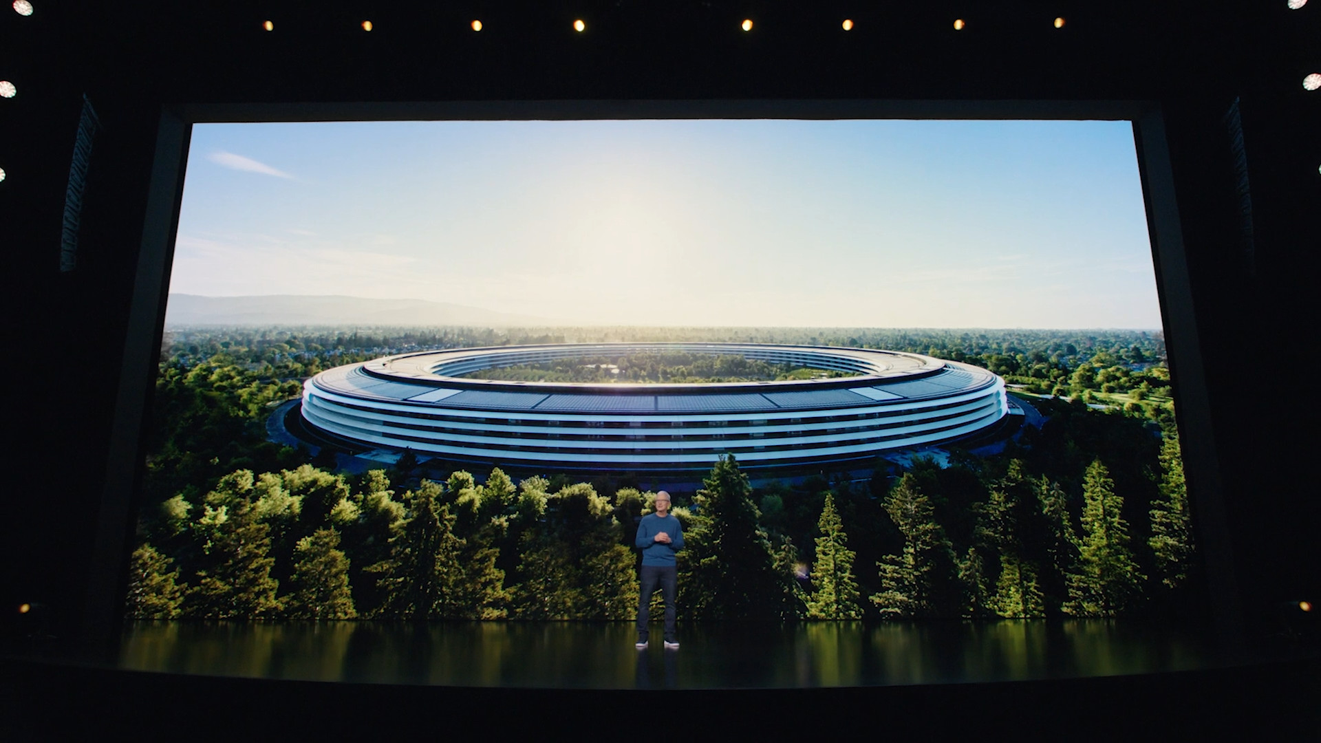 person in front of apple campus