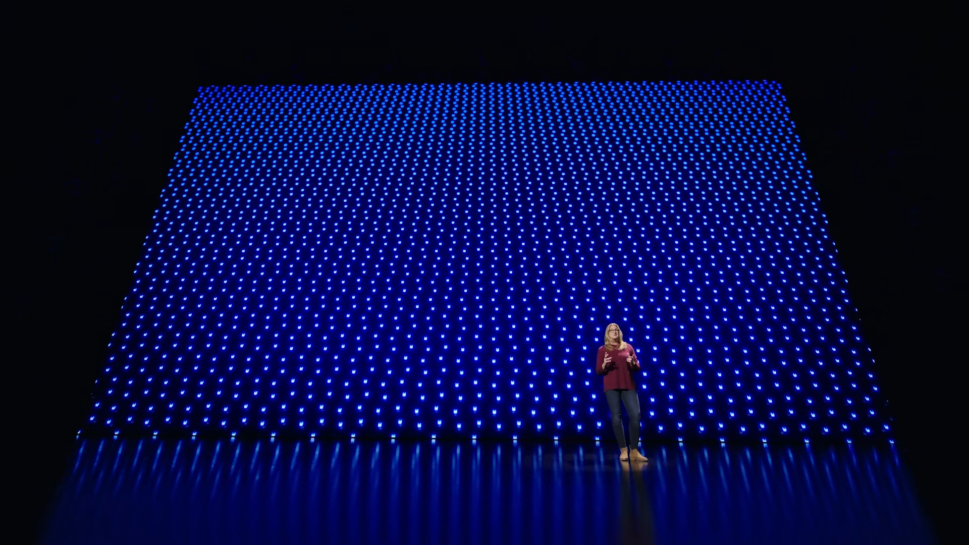 person on stage with blue lights