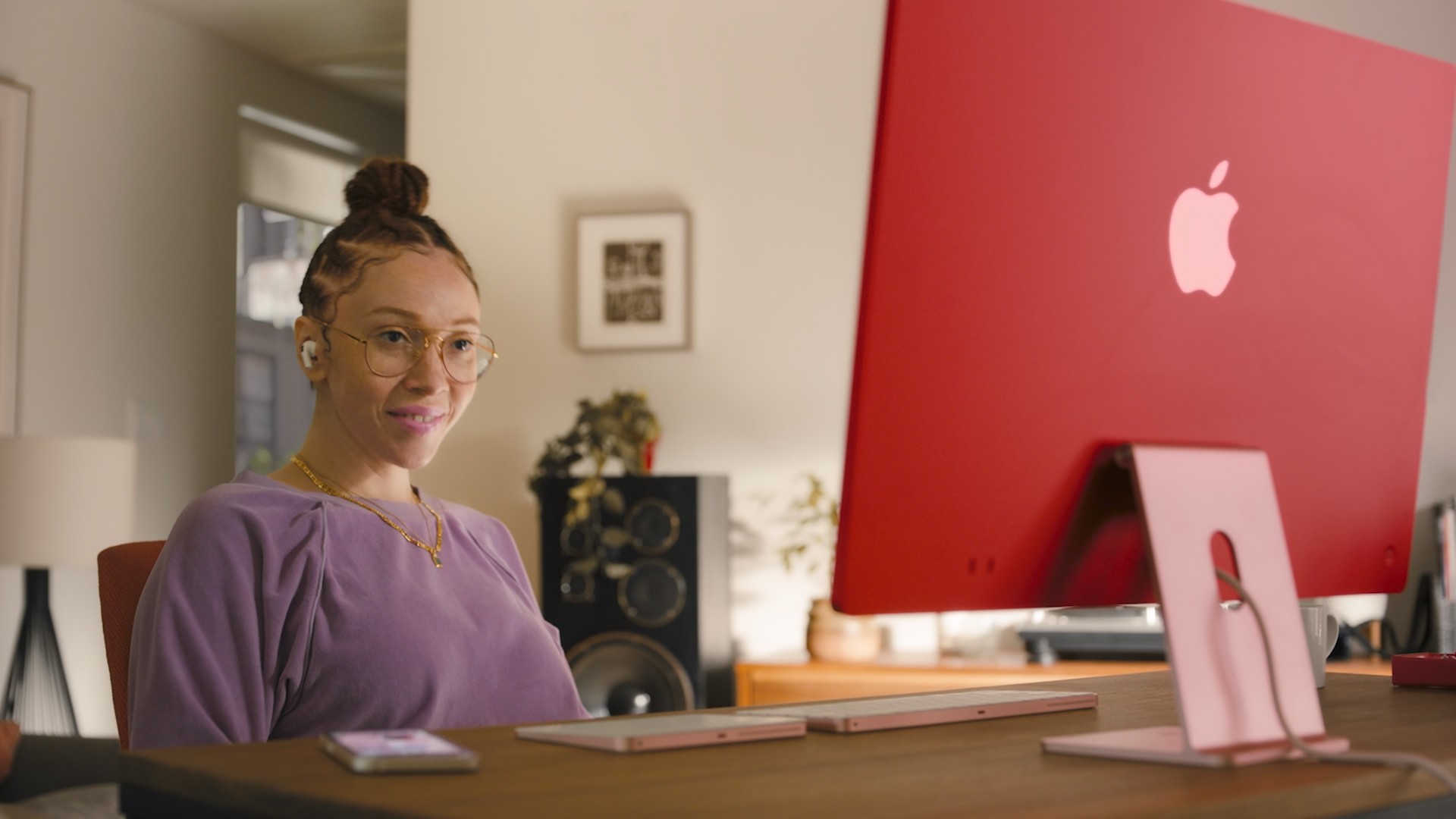 person smiling at red desktop