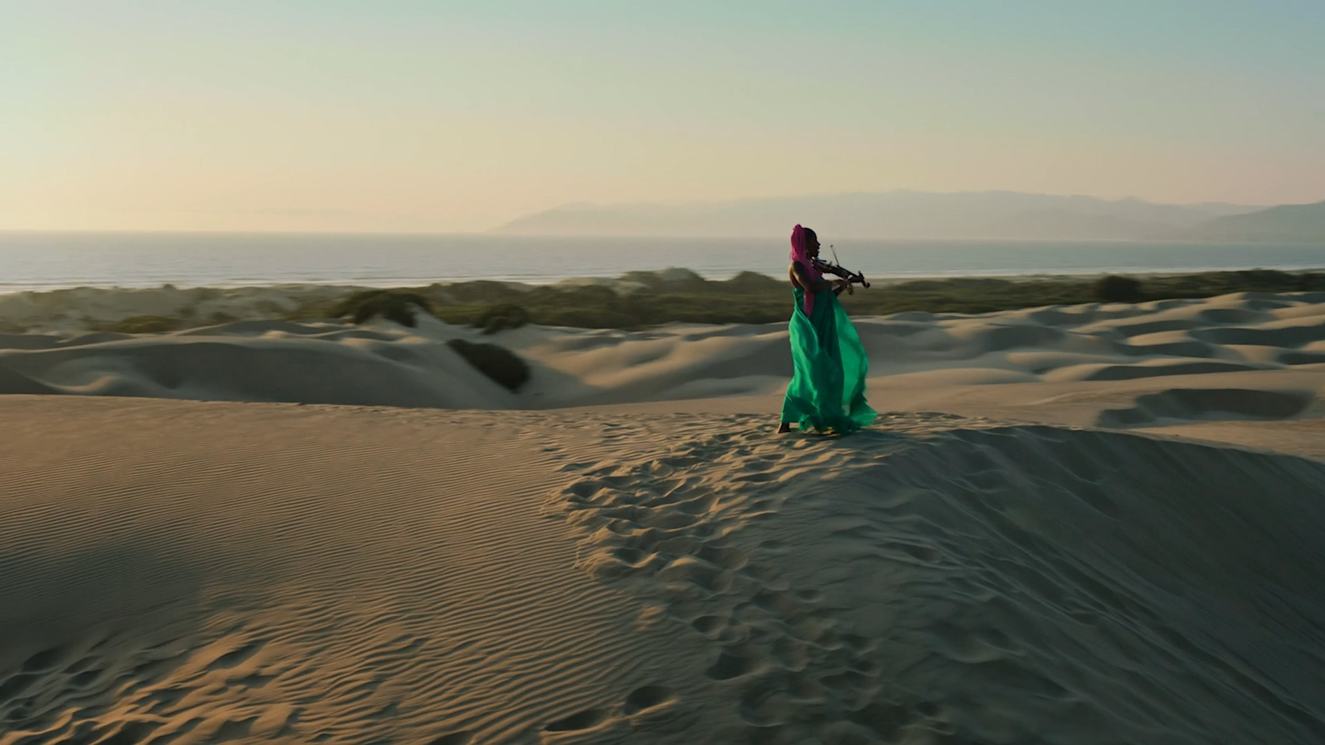 violinist in desert dunes