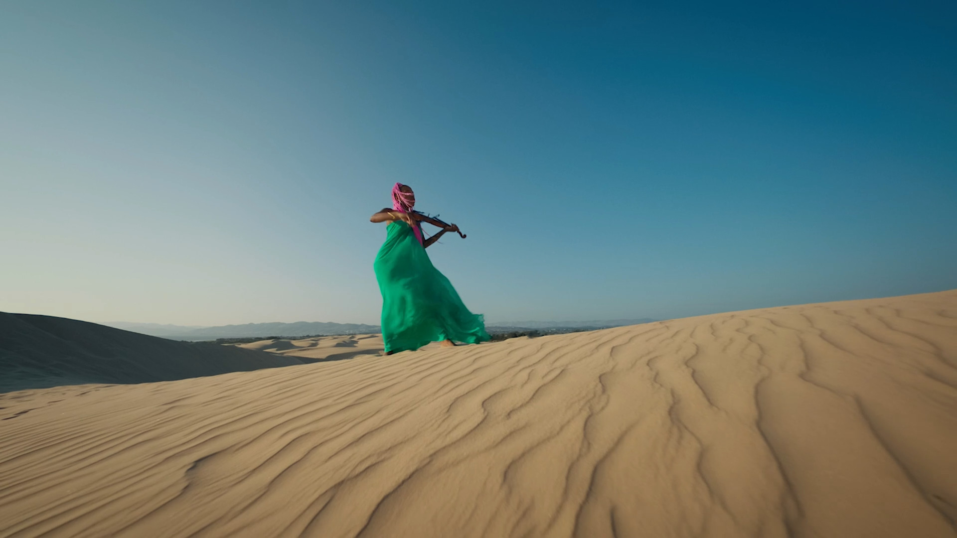 violinist on sand dune