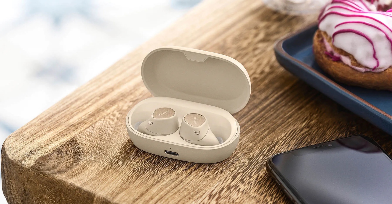 beige wireless earbuds on table