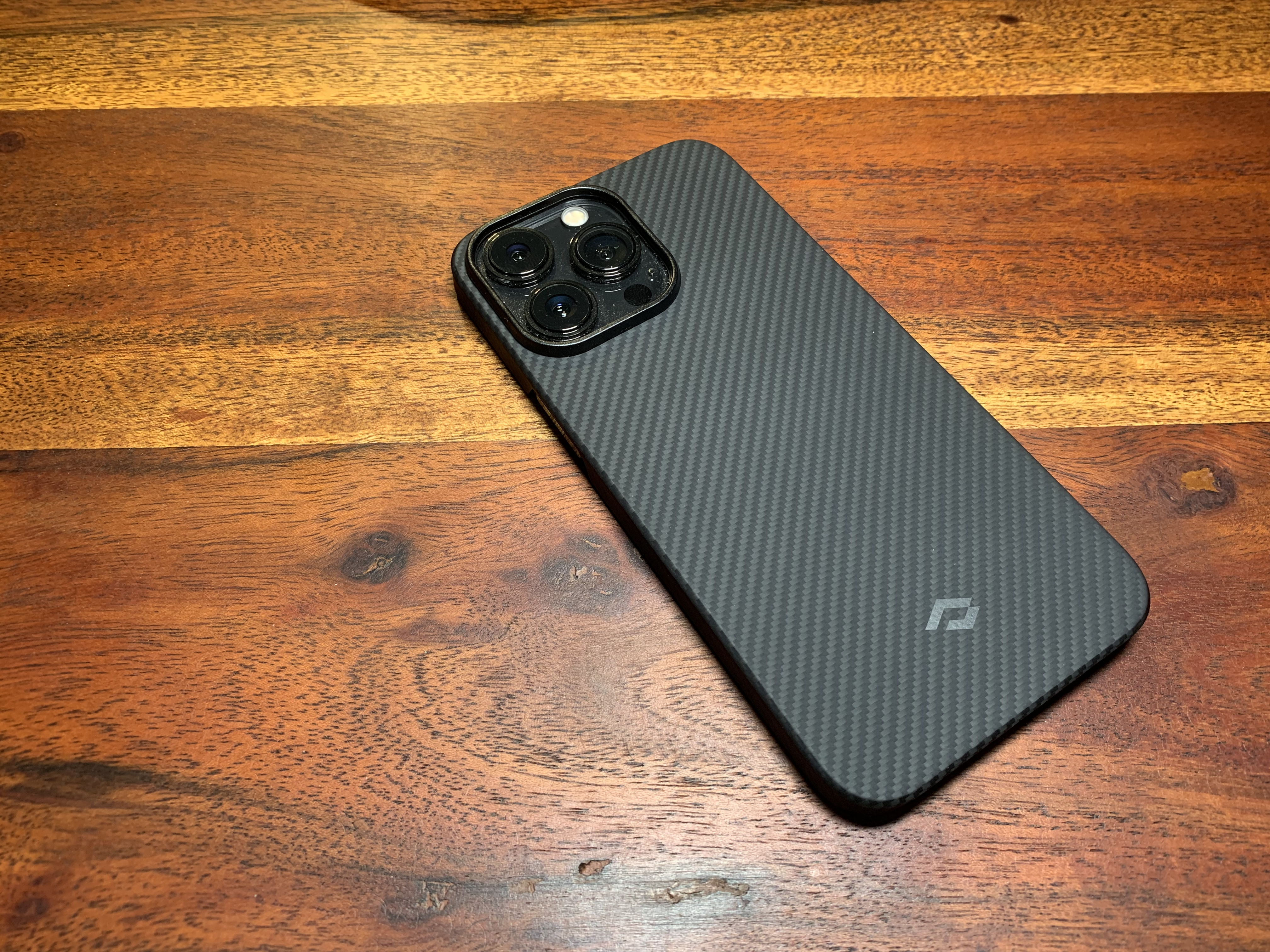 carbon fiber phone case on wooden table