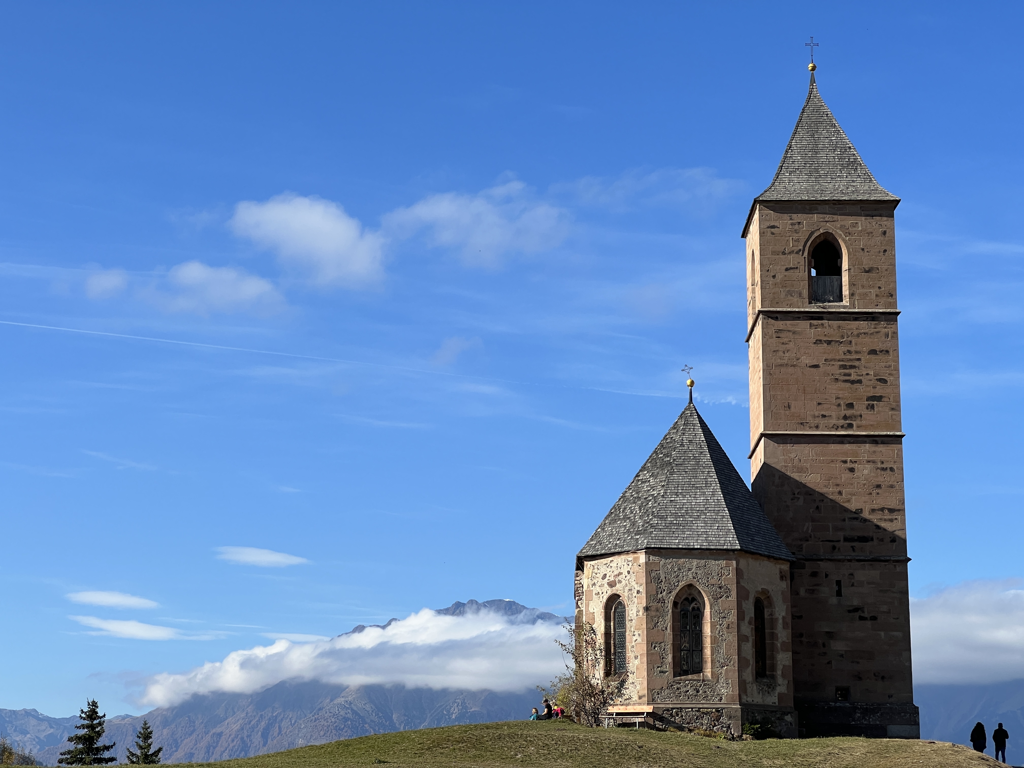 church on hill with mountains