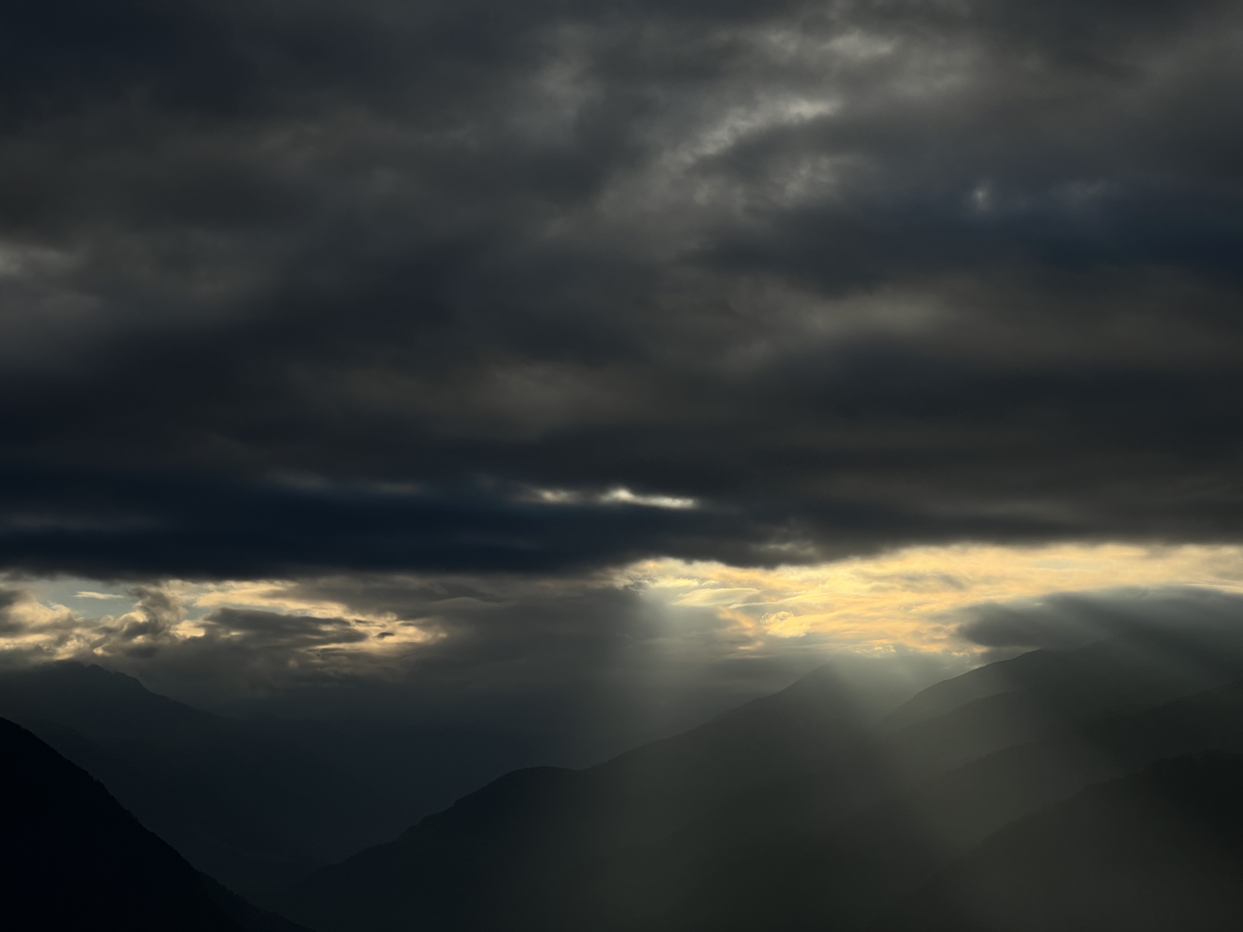 clouds and sun rays over mountains