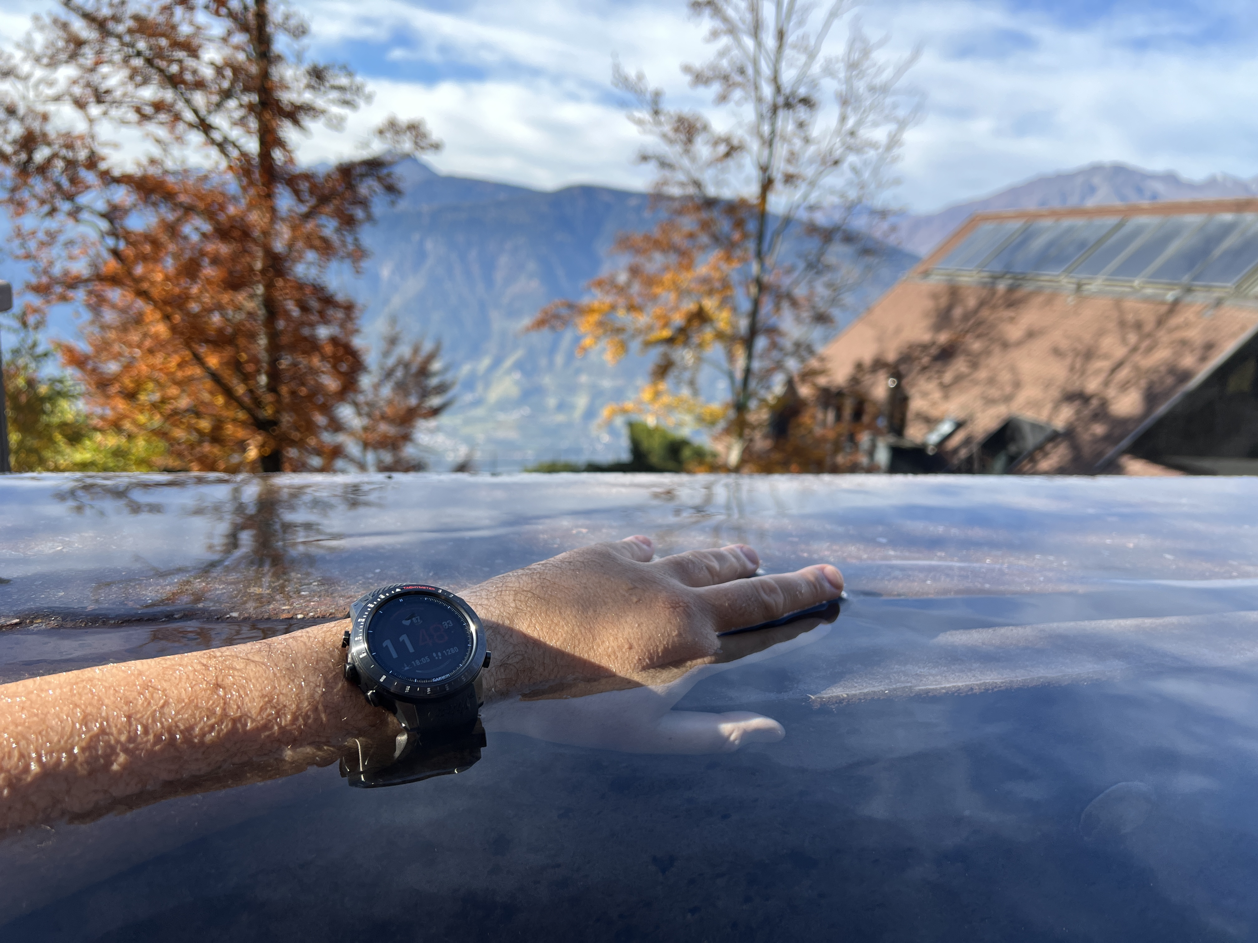hand with smartwatch in water