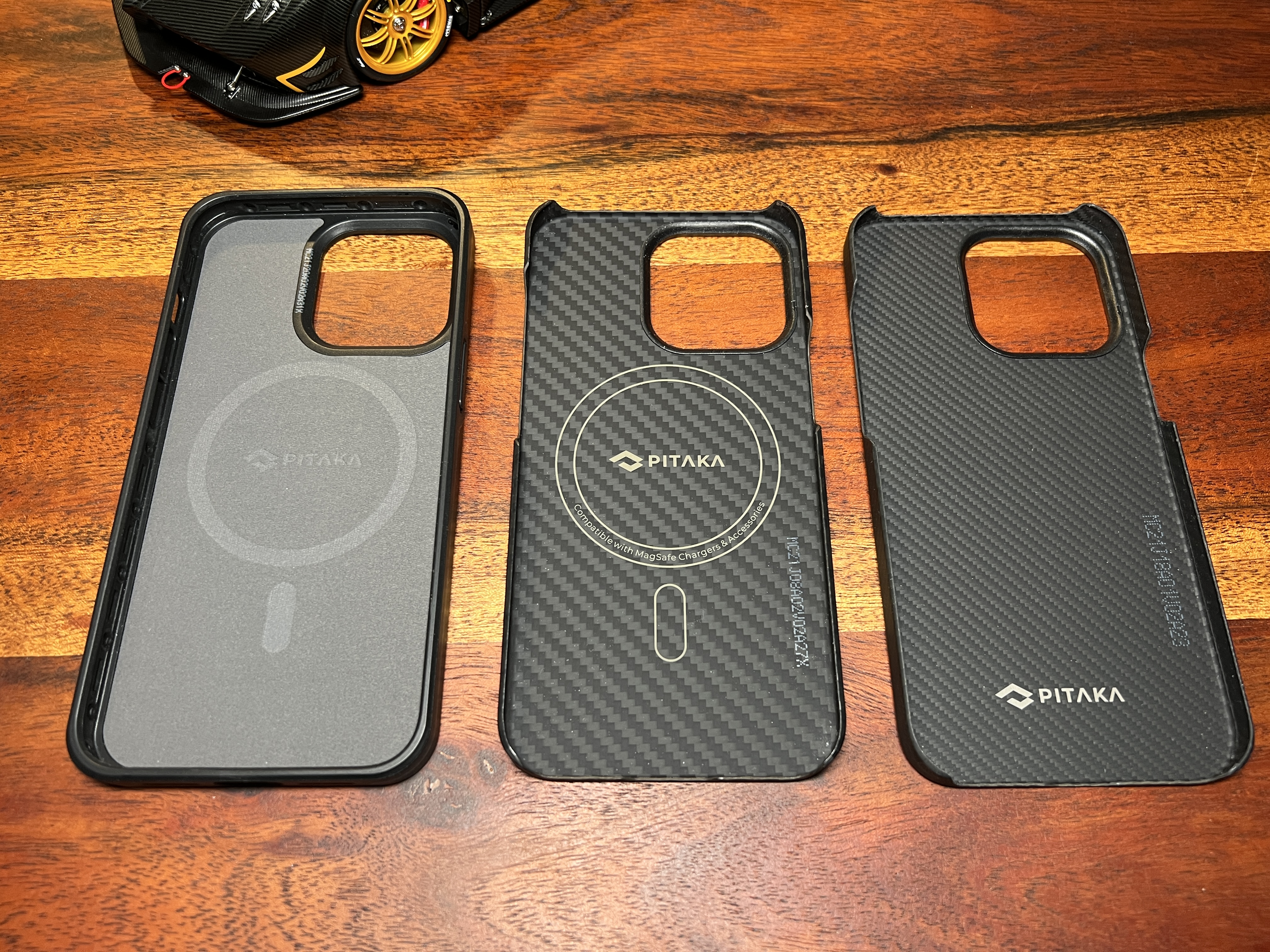 three phone cases on wood