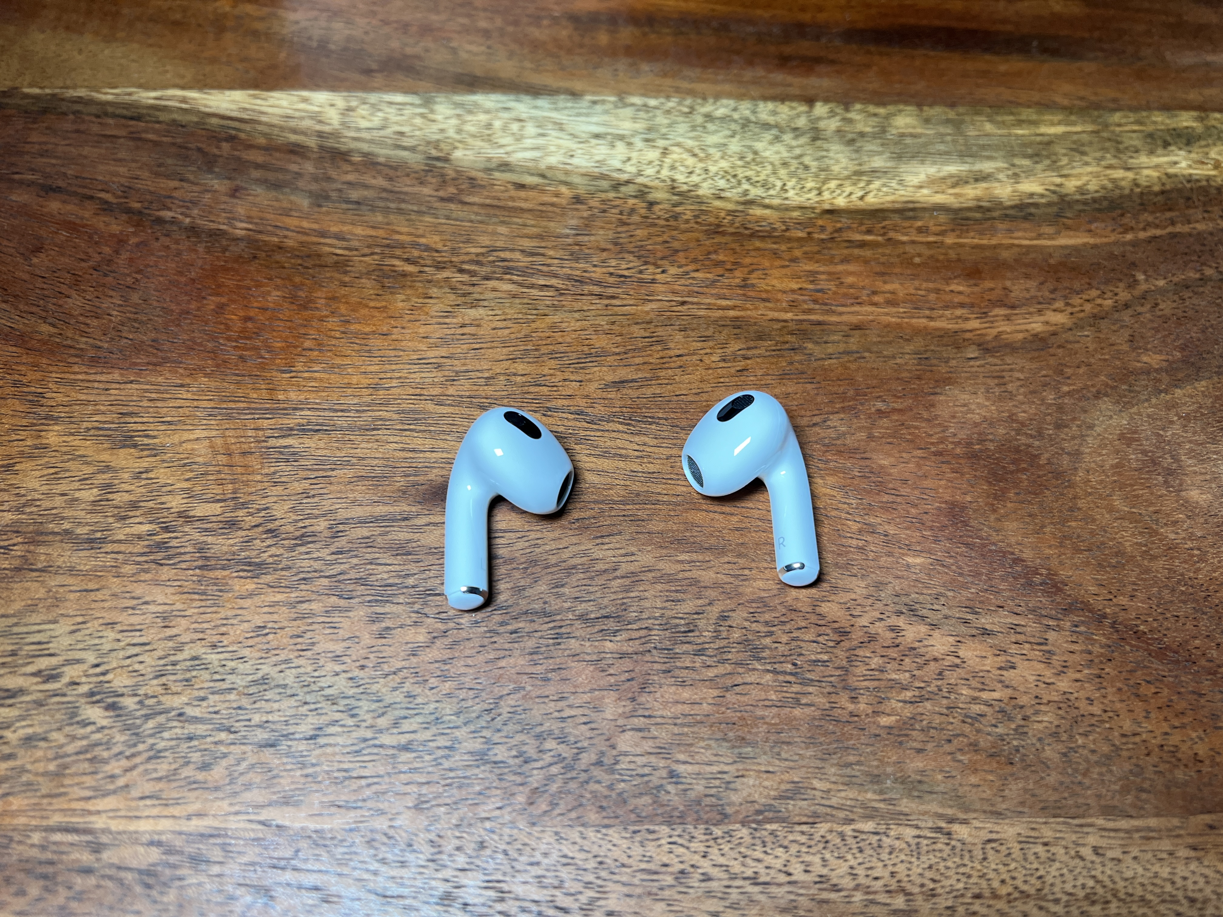 wireless earbuds on wood