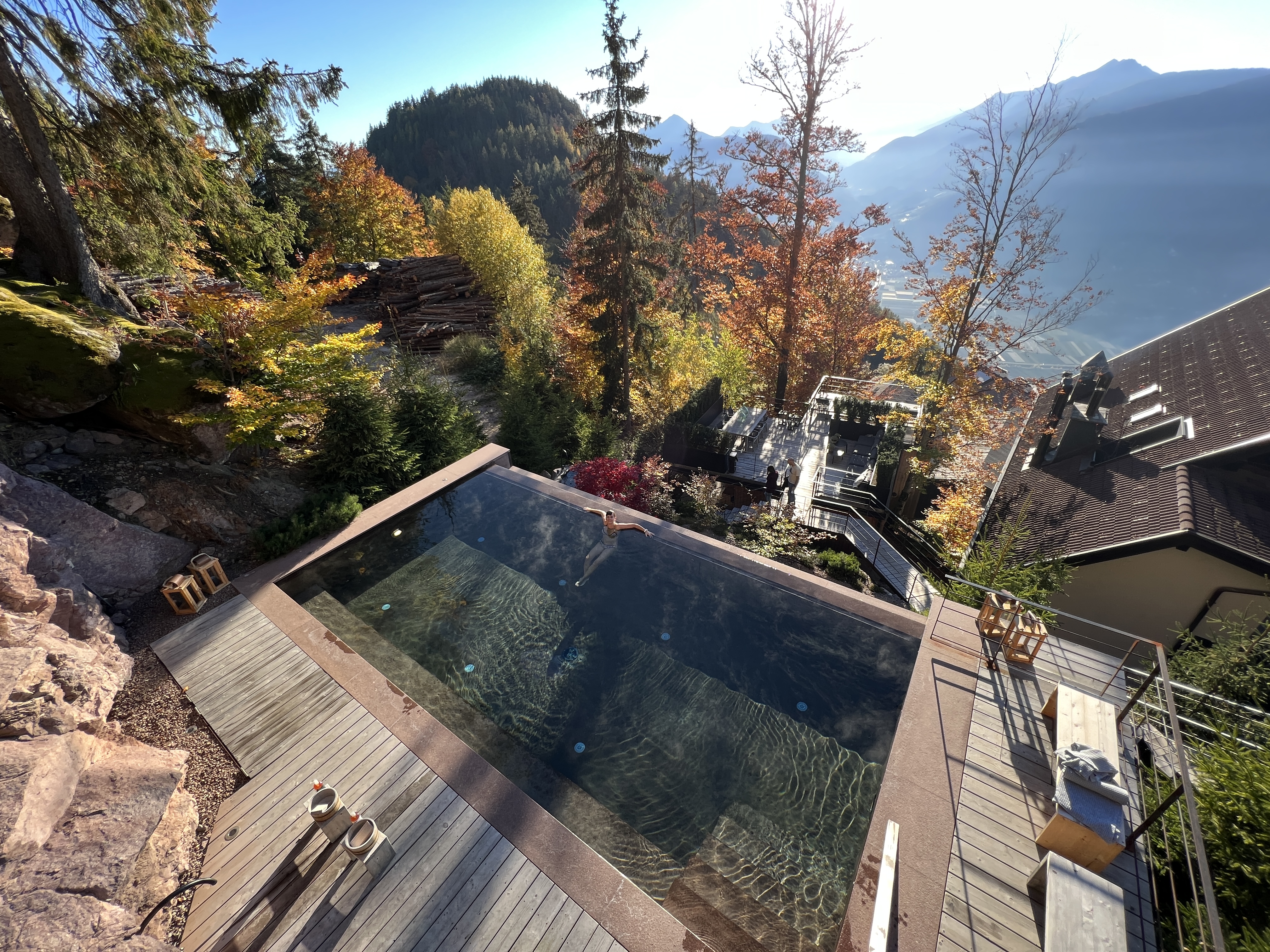wooden deck with pool and mountain view