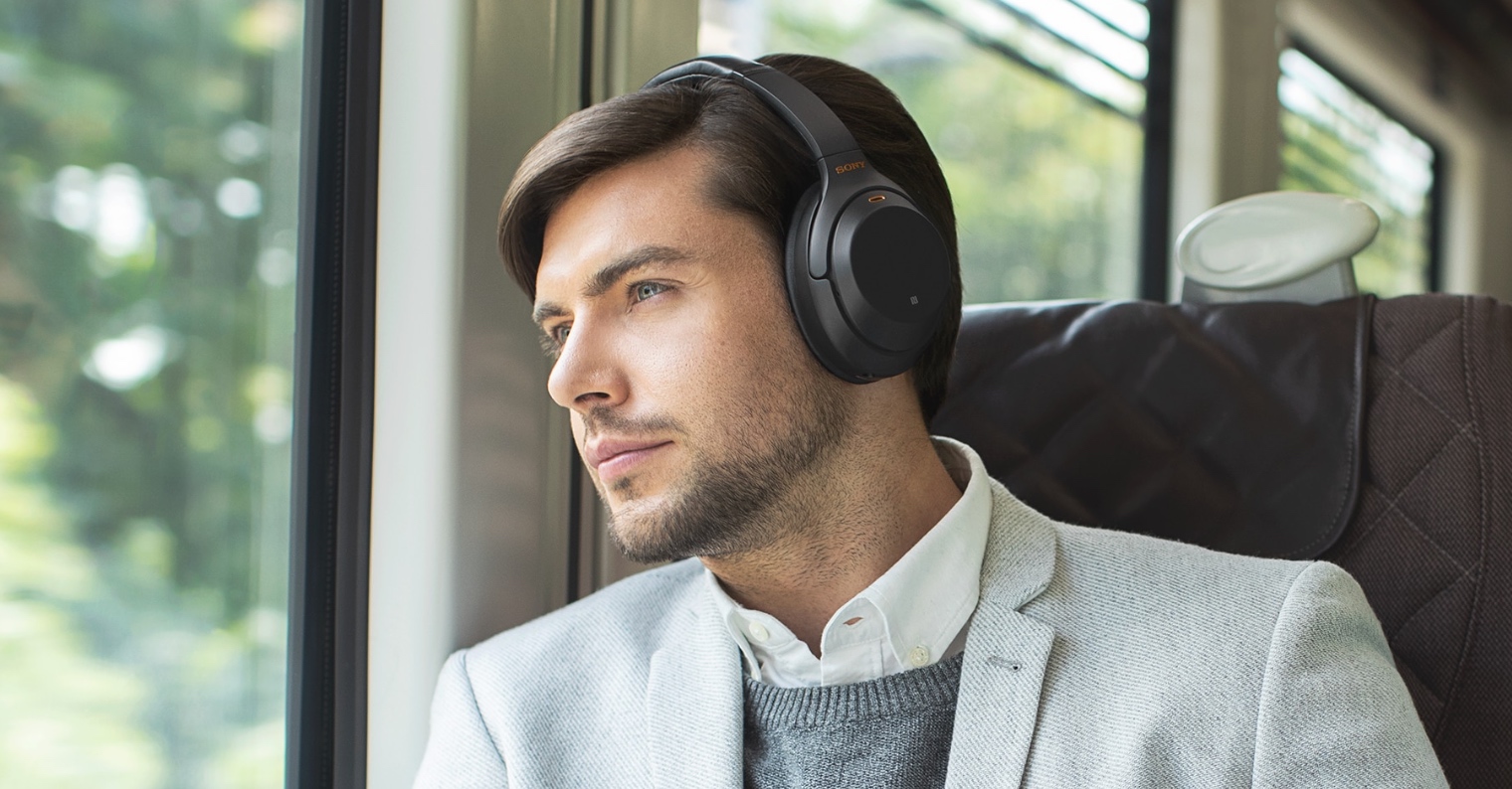 man wearing headphones on train