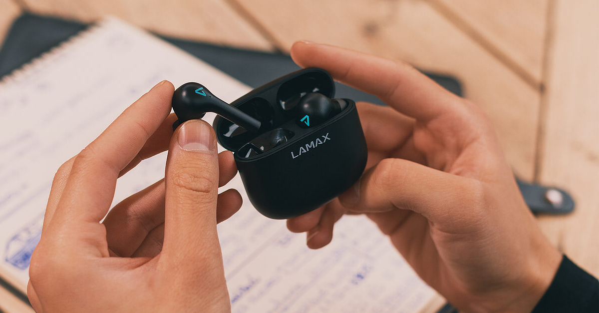 wireless earbuds in hand