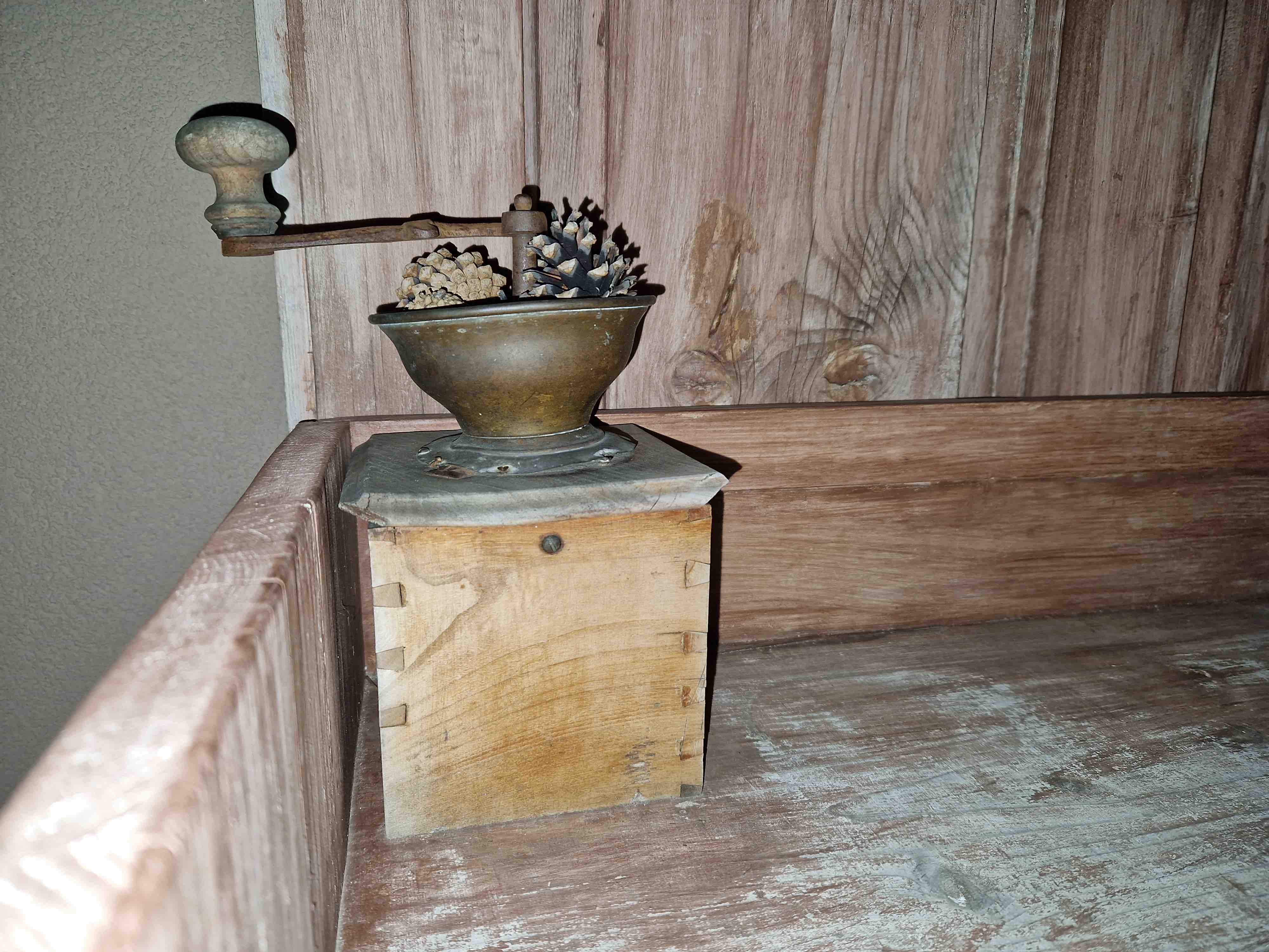 antique coffee grinder on wooden table
