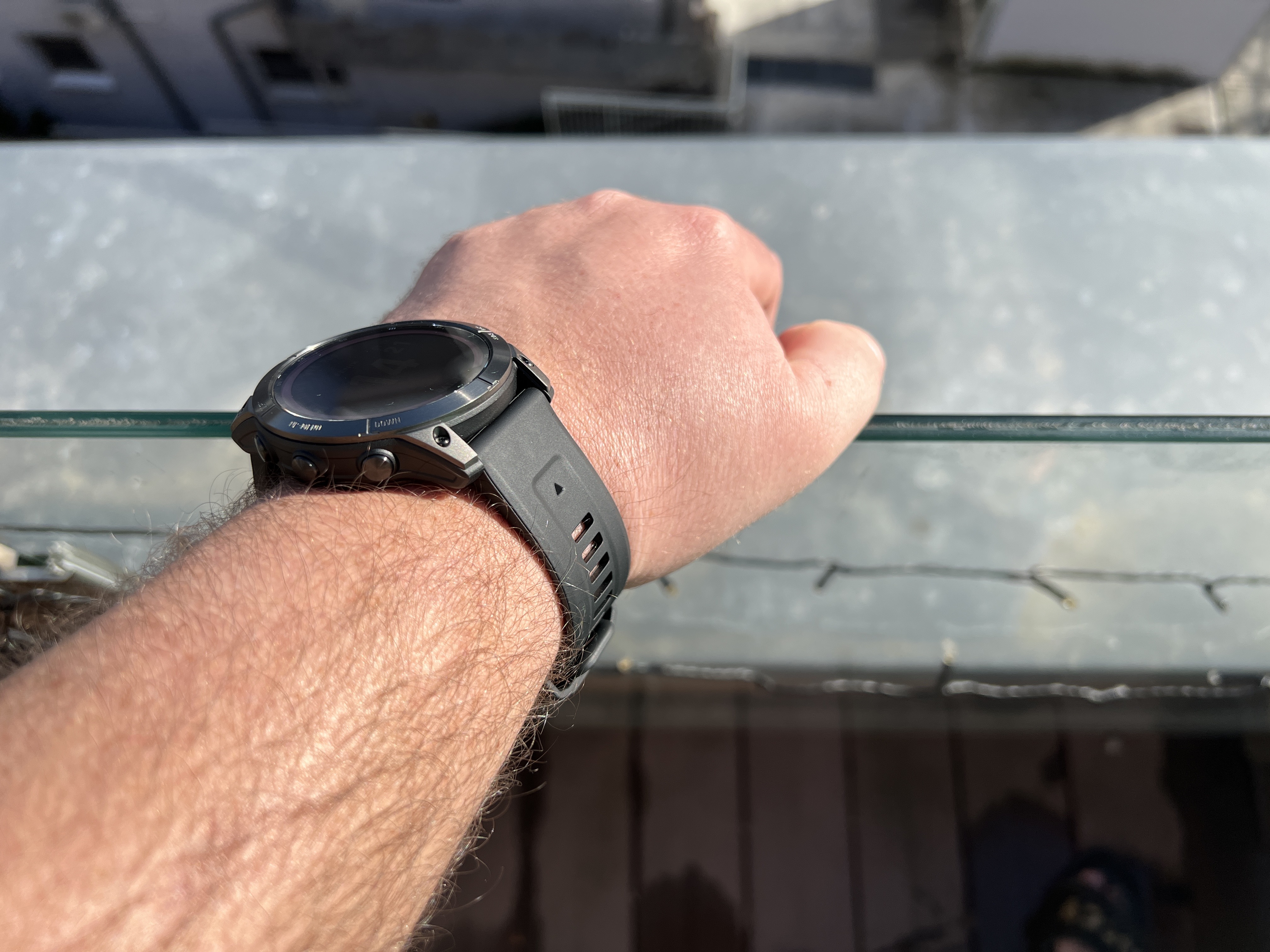 hand with watch on balcony