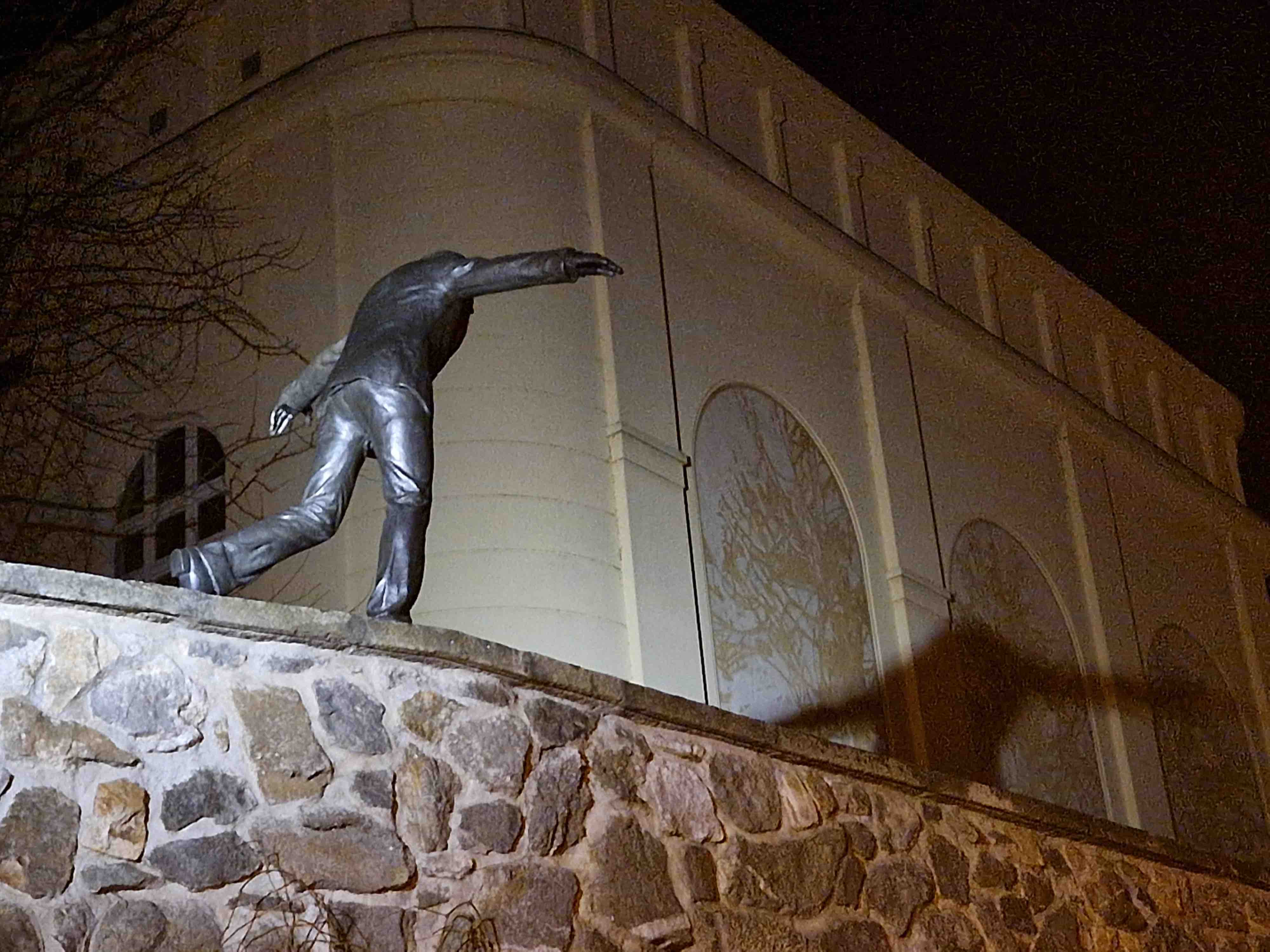 nighttime statue on wall