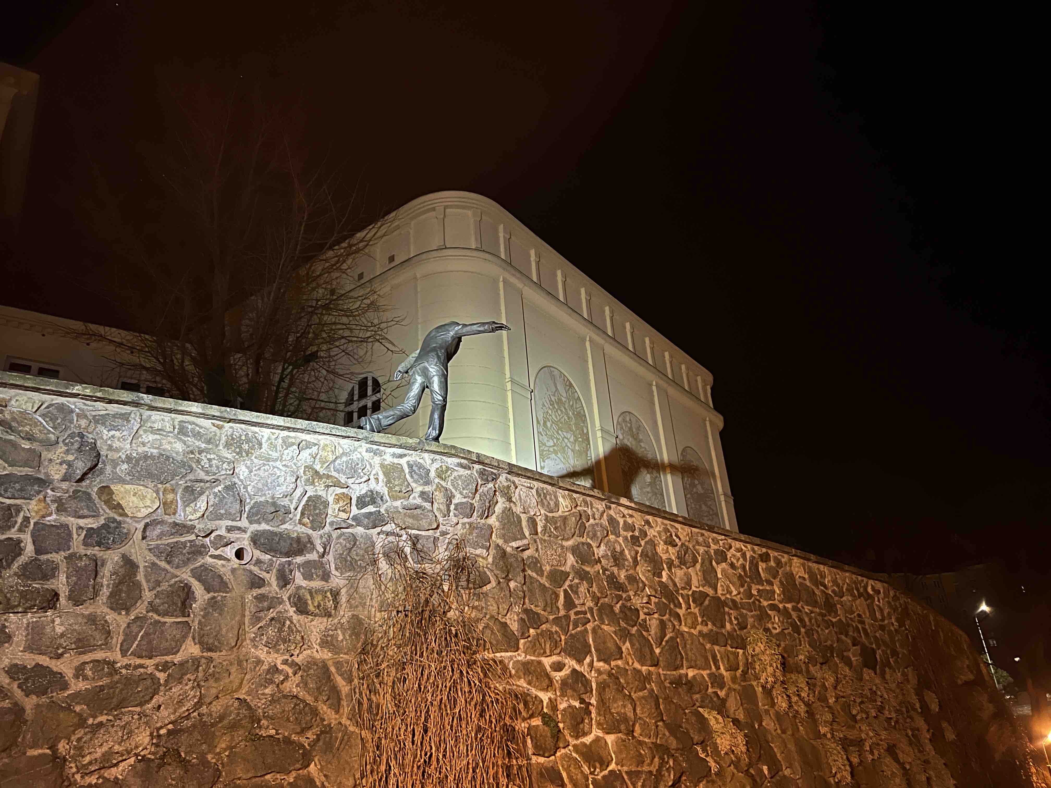 statue on stone wall at night