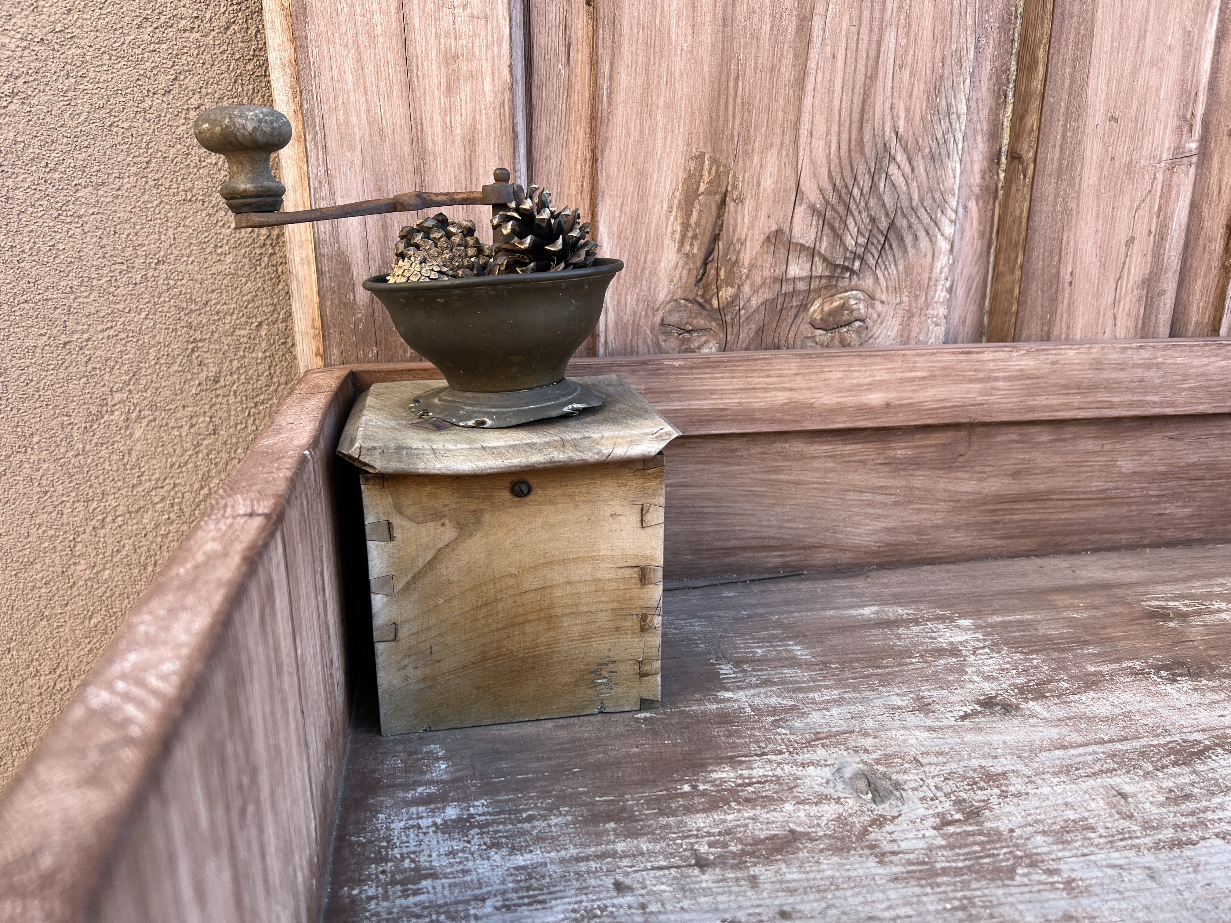 antique coffee grinder on wooden surface