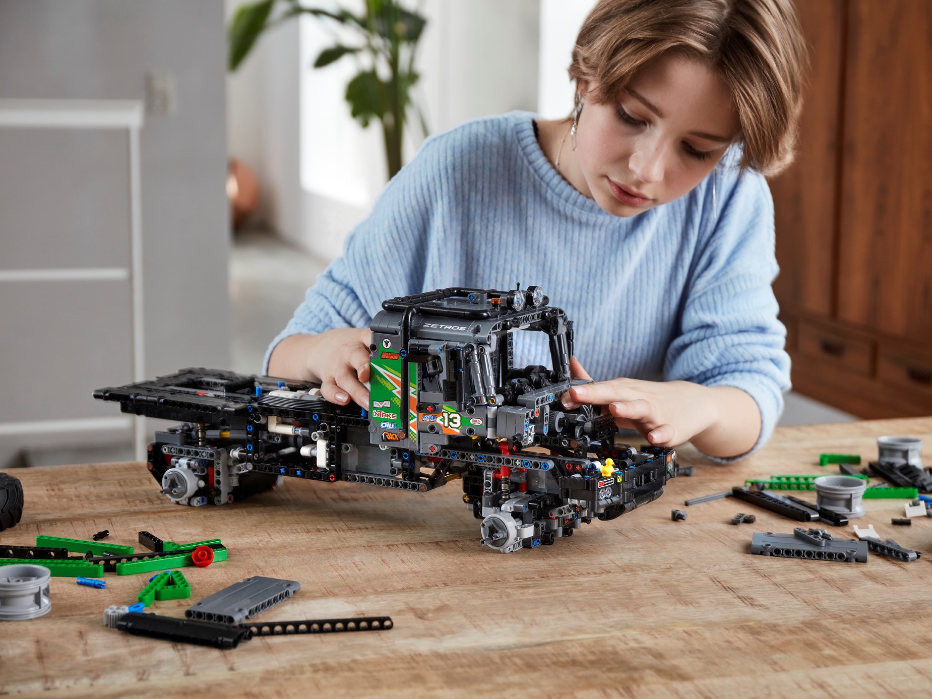 child building lego truck