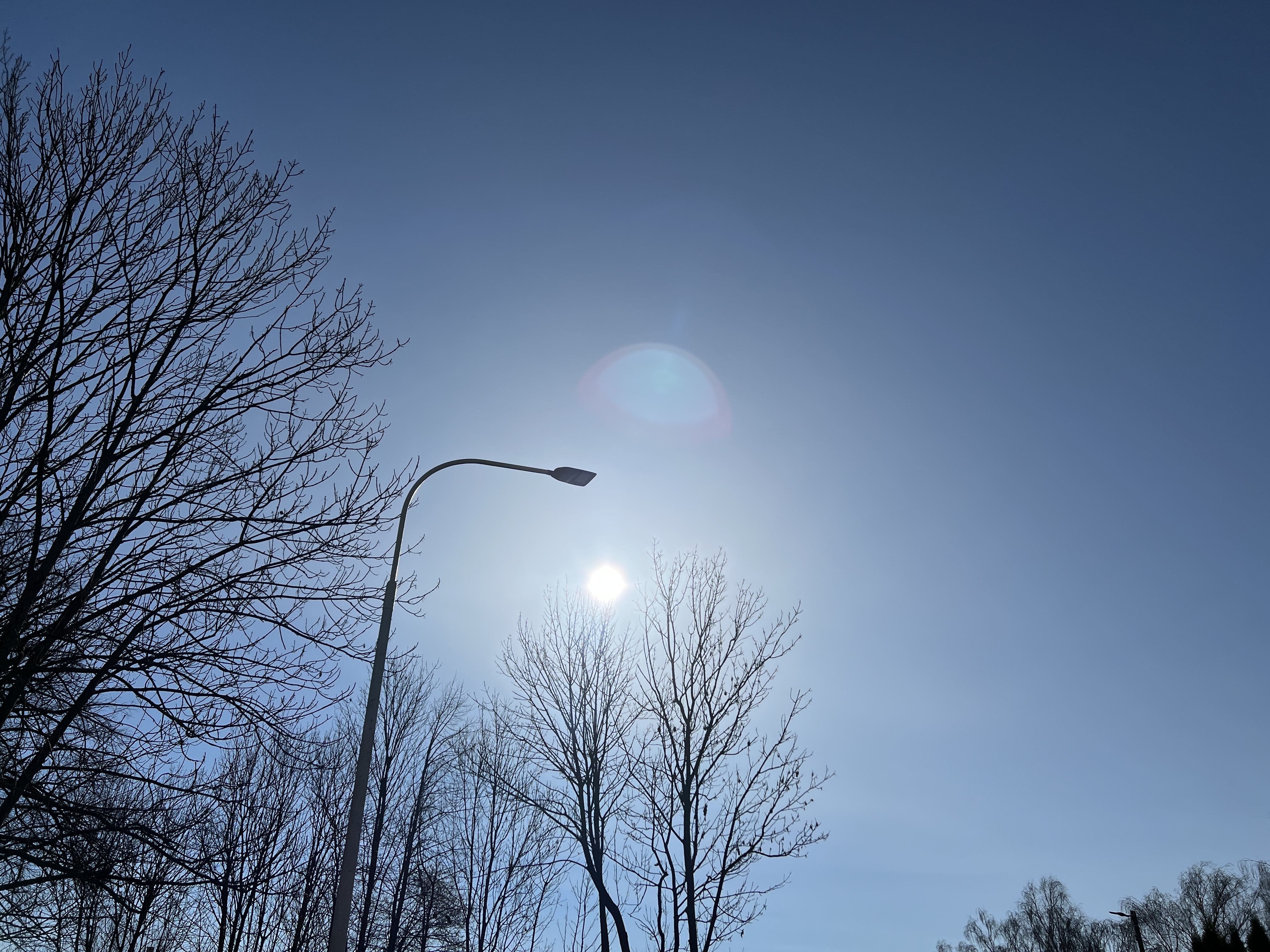 streetlamp and sun in clear sky