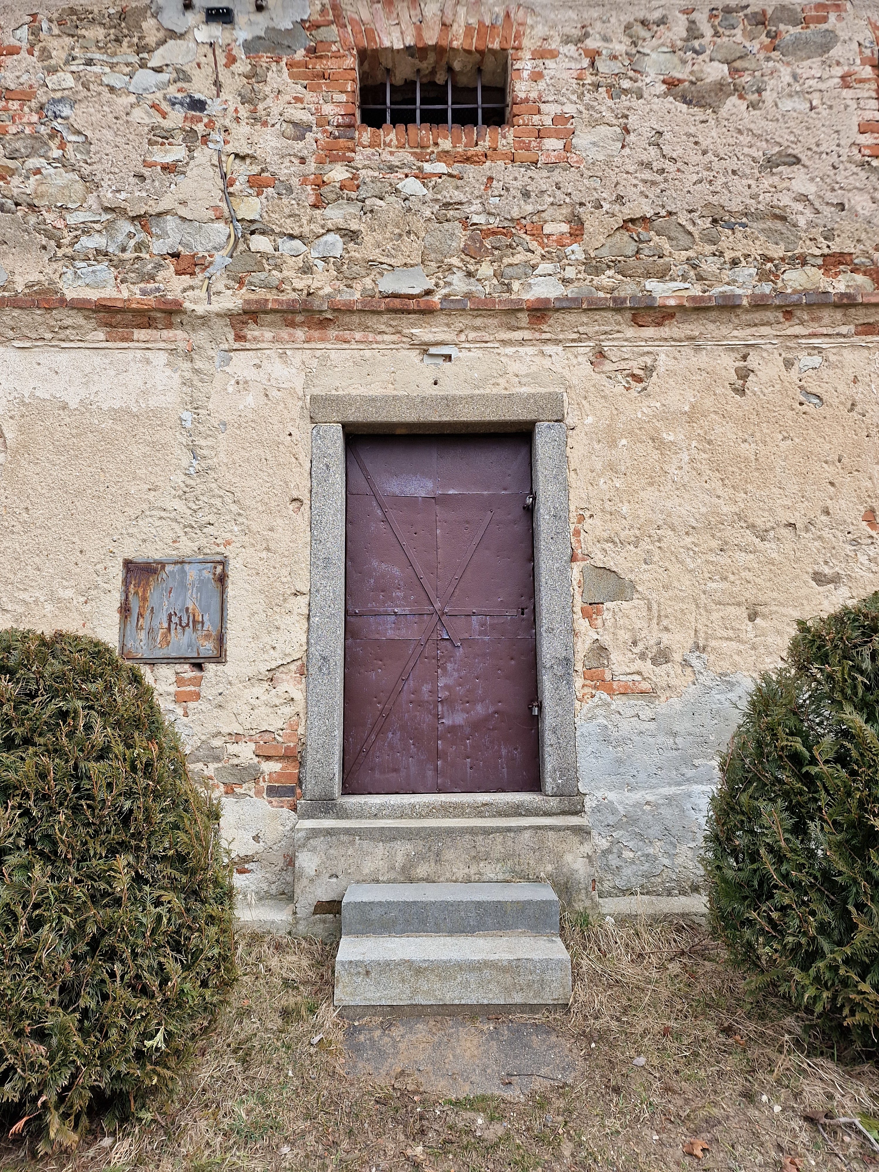 weathered door on brick wall
