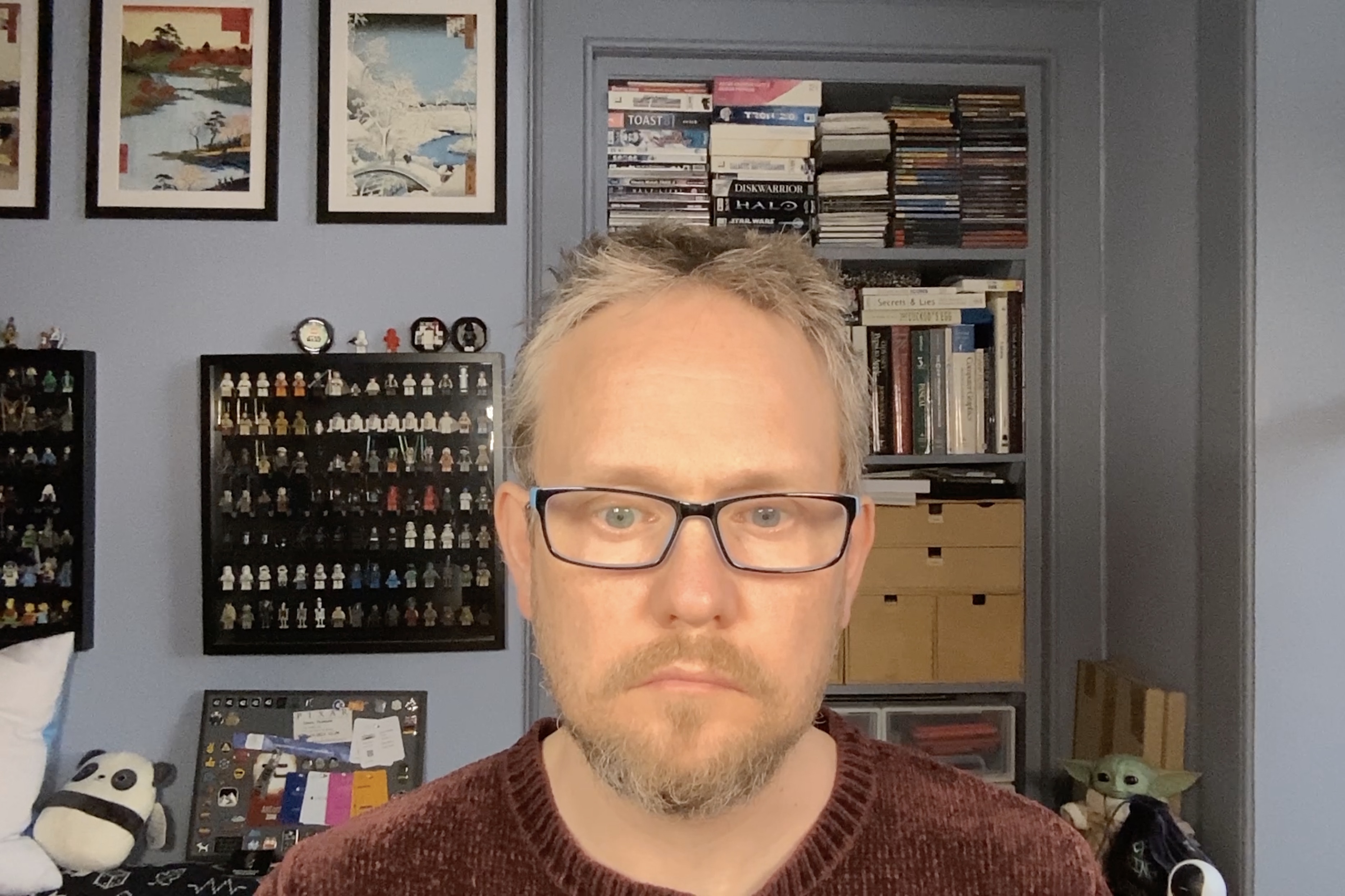 man in room with books and figures