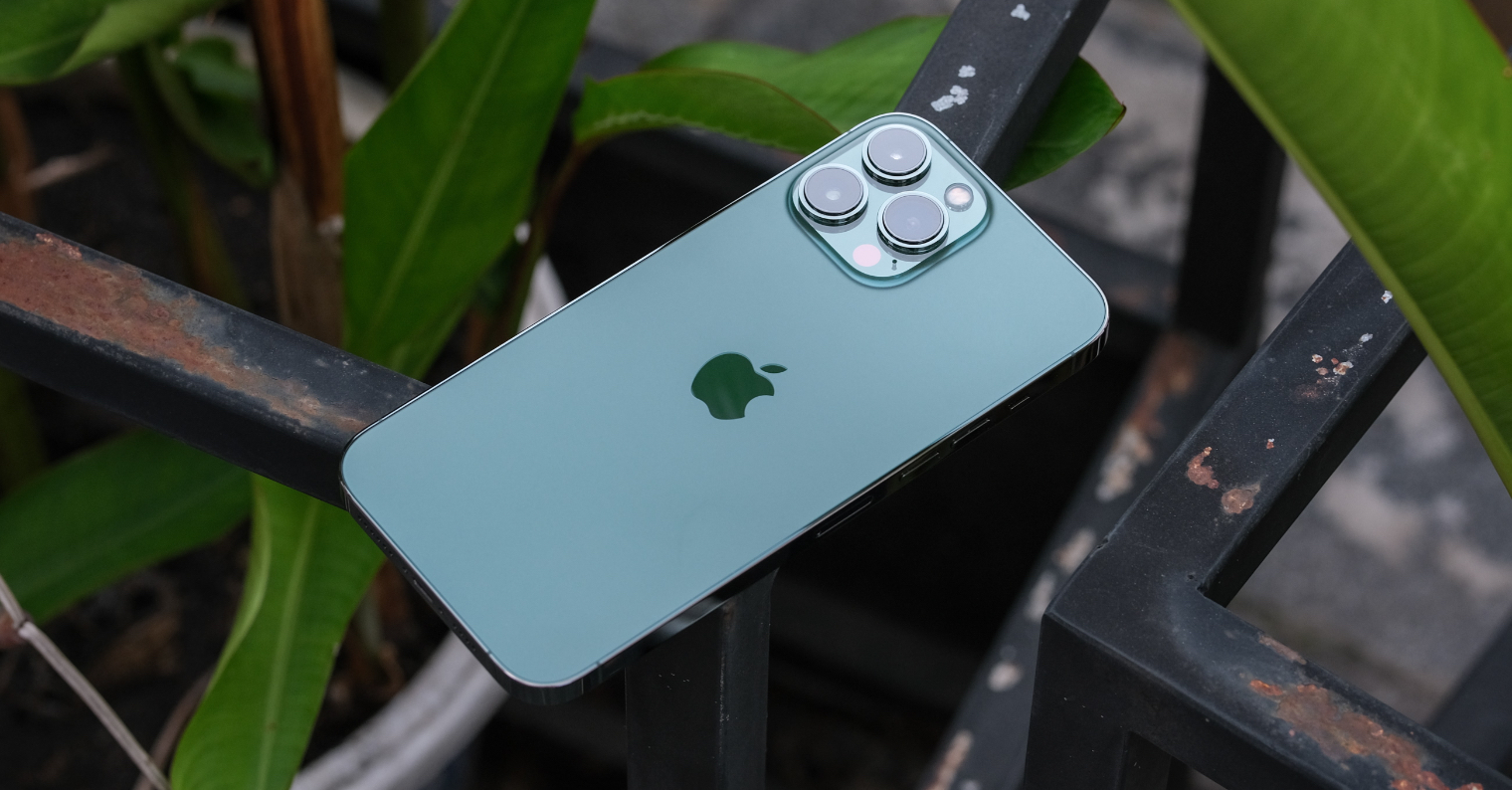 green smartphone on metal rail