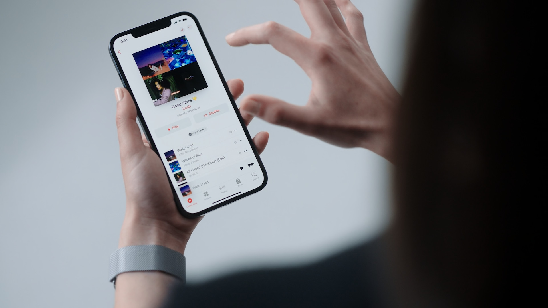 hand holding iphone music app