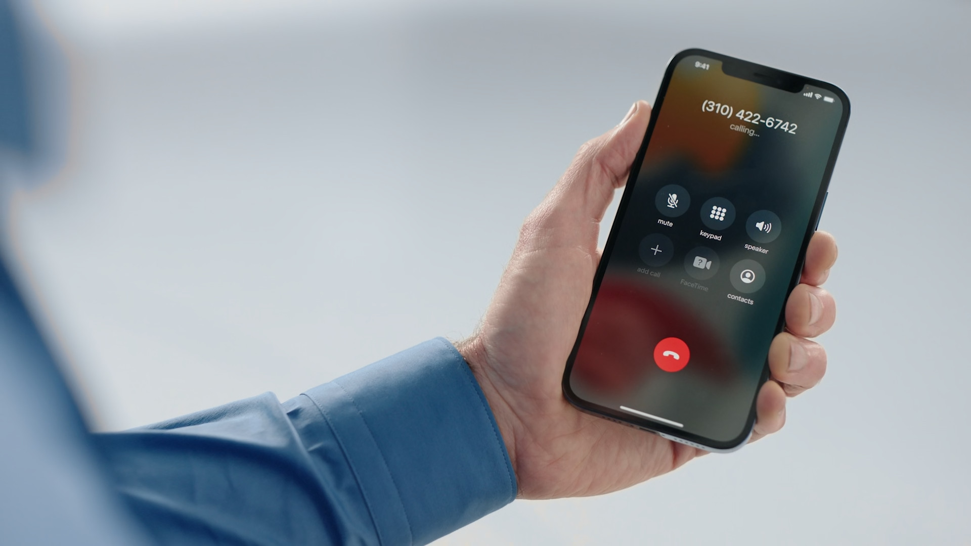 hand holding smartphone dialing