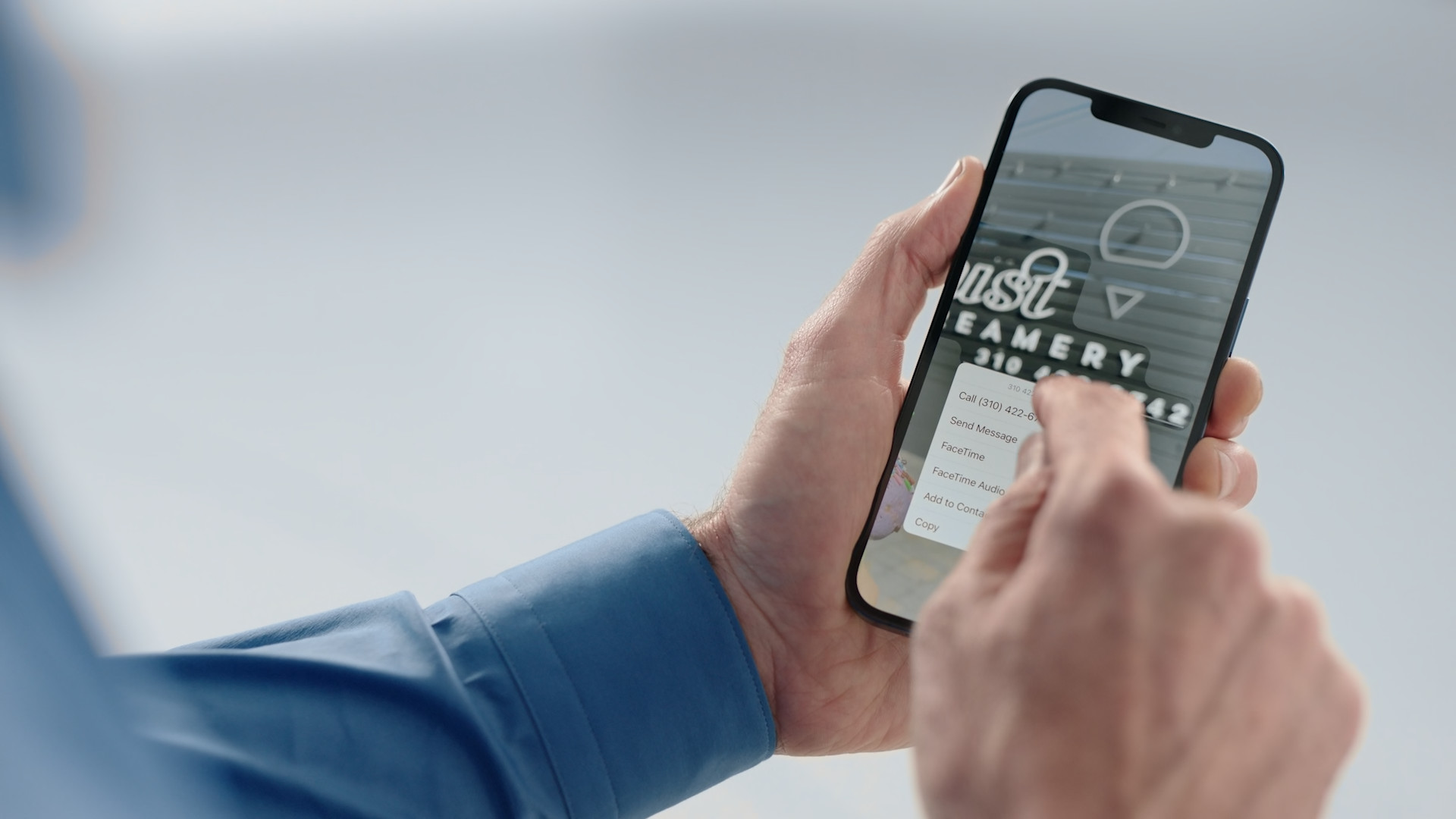 hand holding smartphone with app