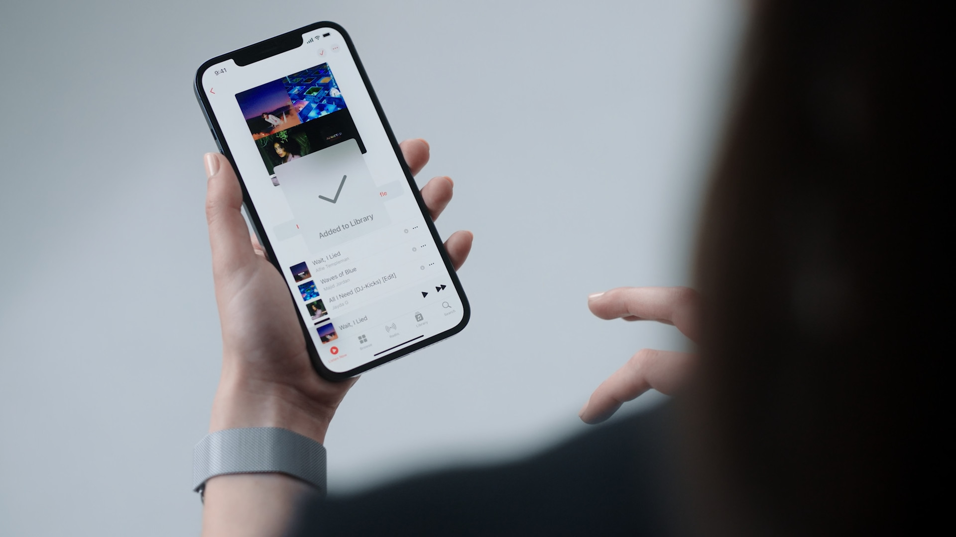 hand using iphone music app