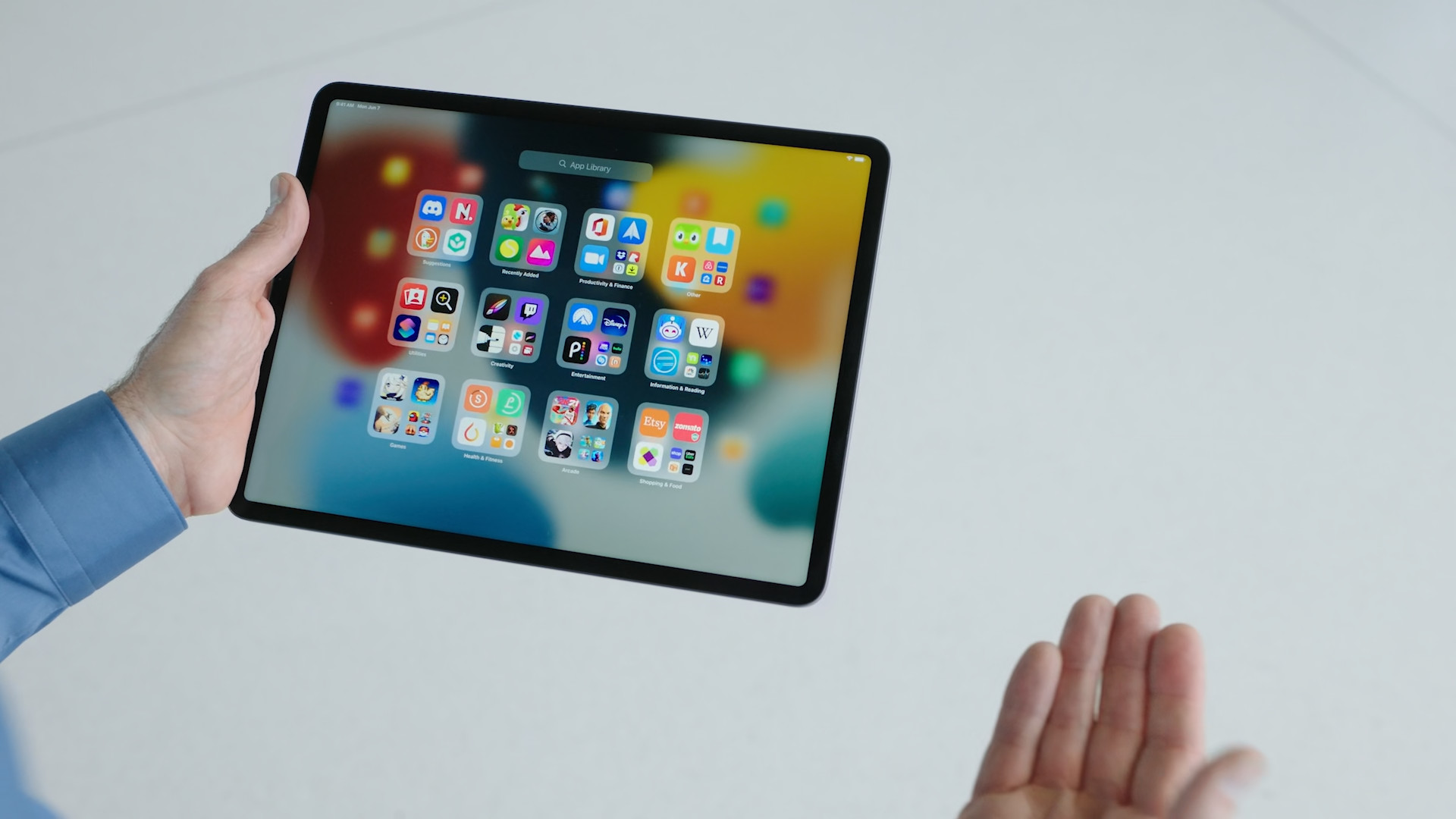 person holding ipad apps screen
