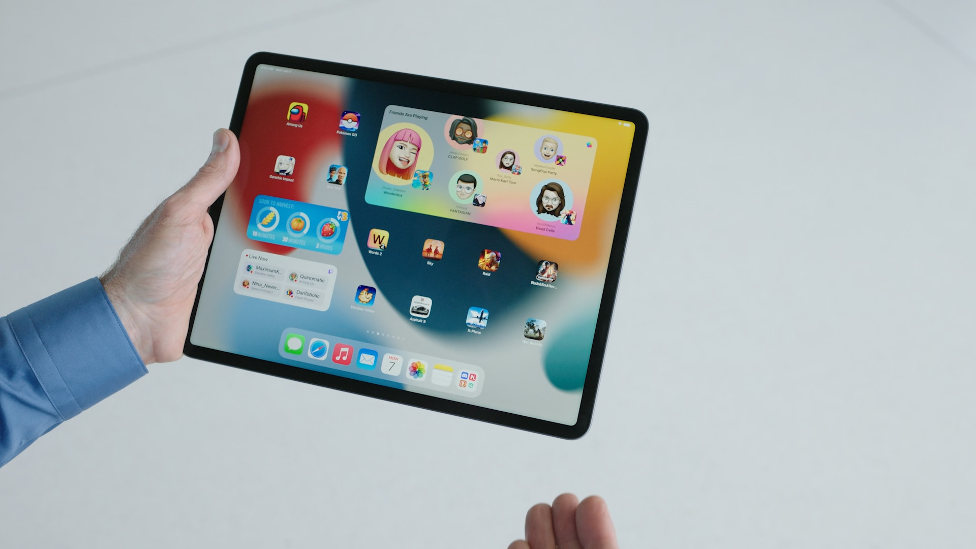 person holding ipad multitasking screen