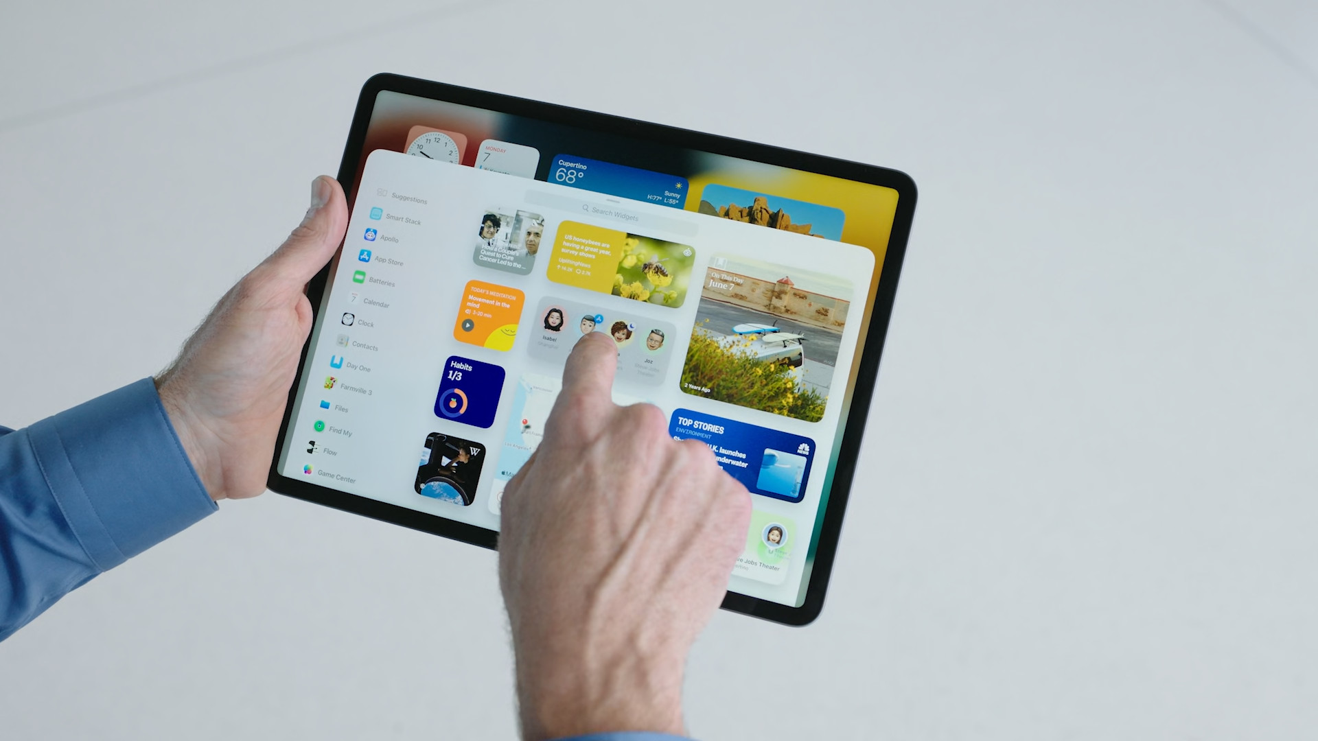 person interacting with ipad widgets