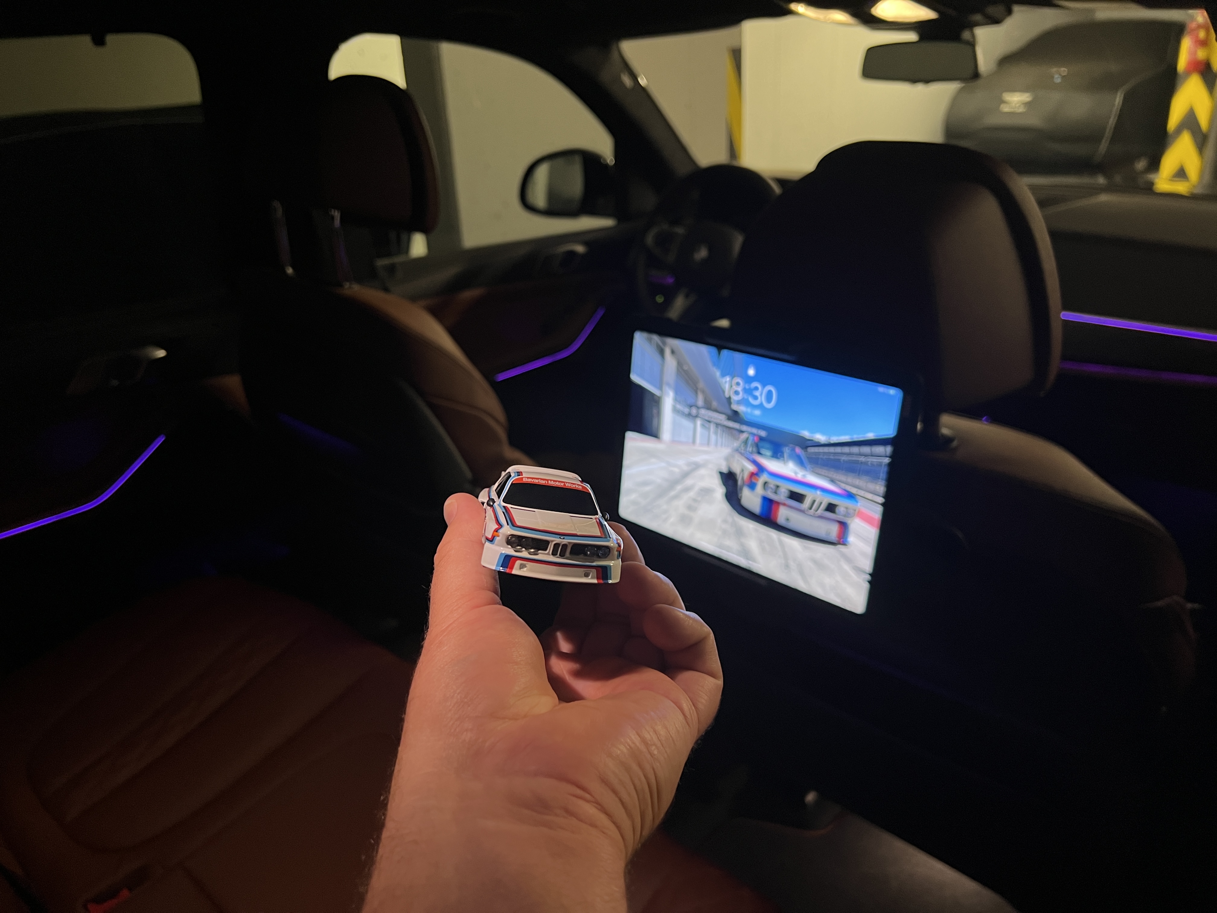 hand holding miniature car in car interior