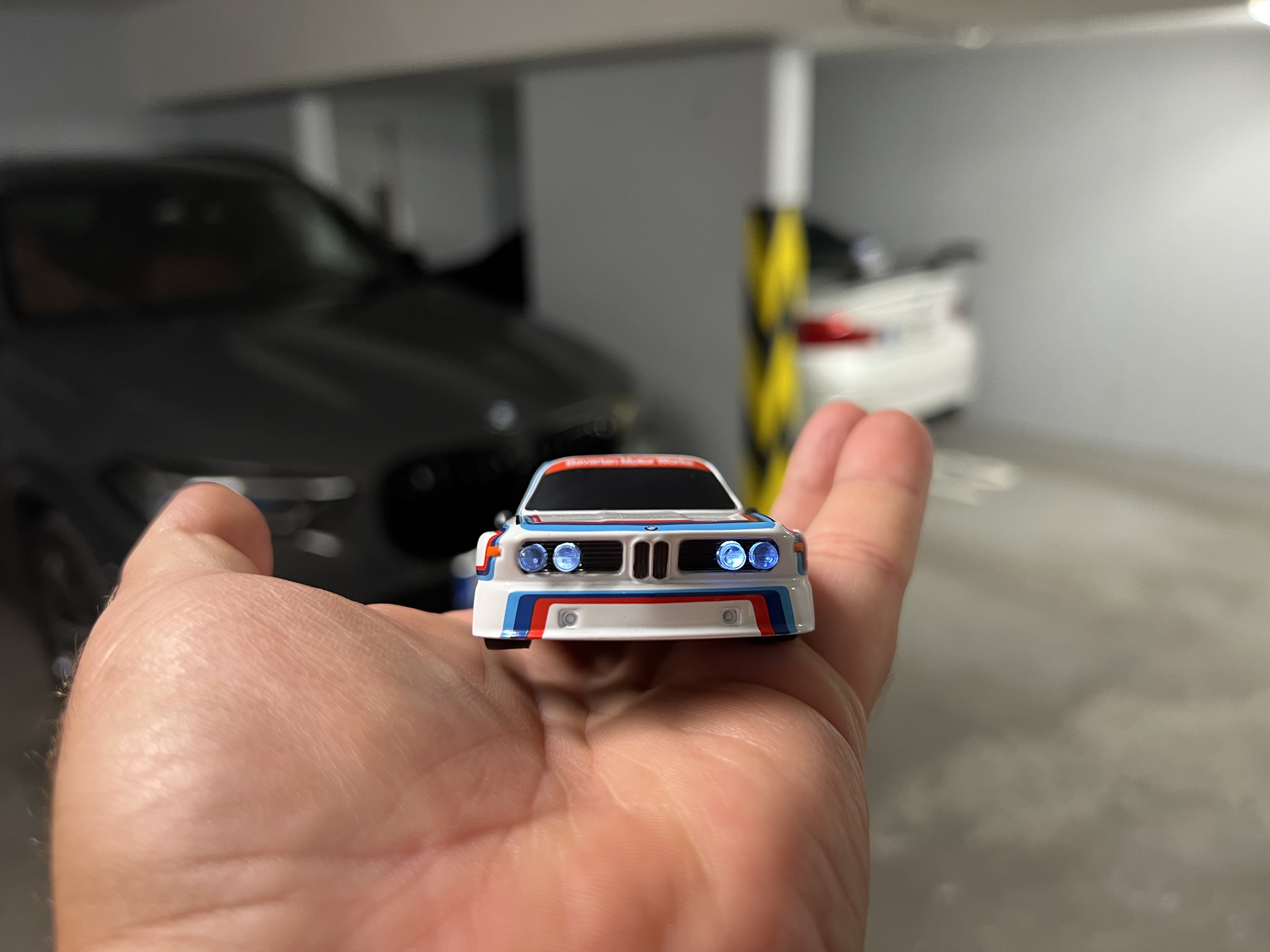 miniature bmw car in hand