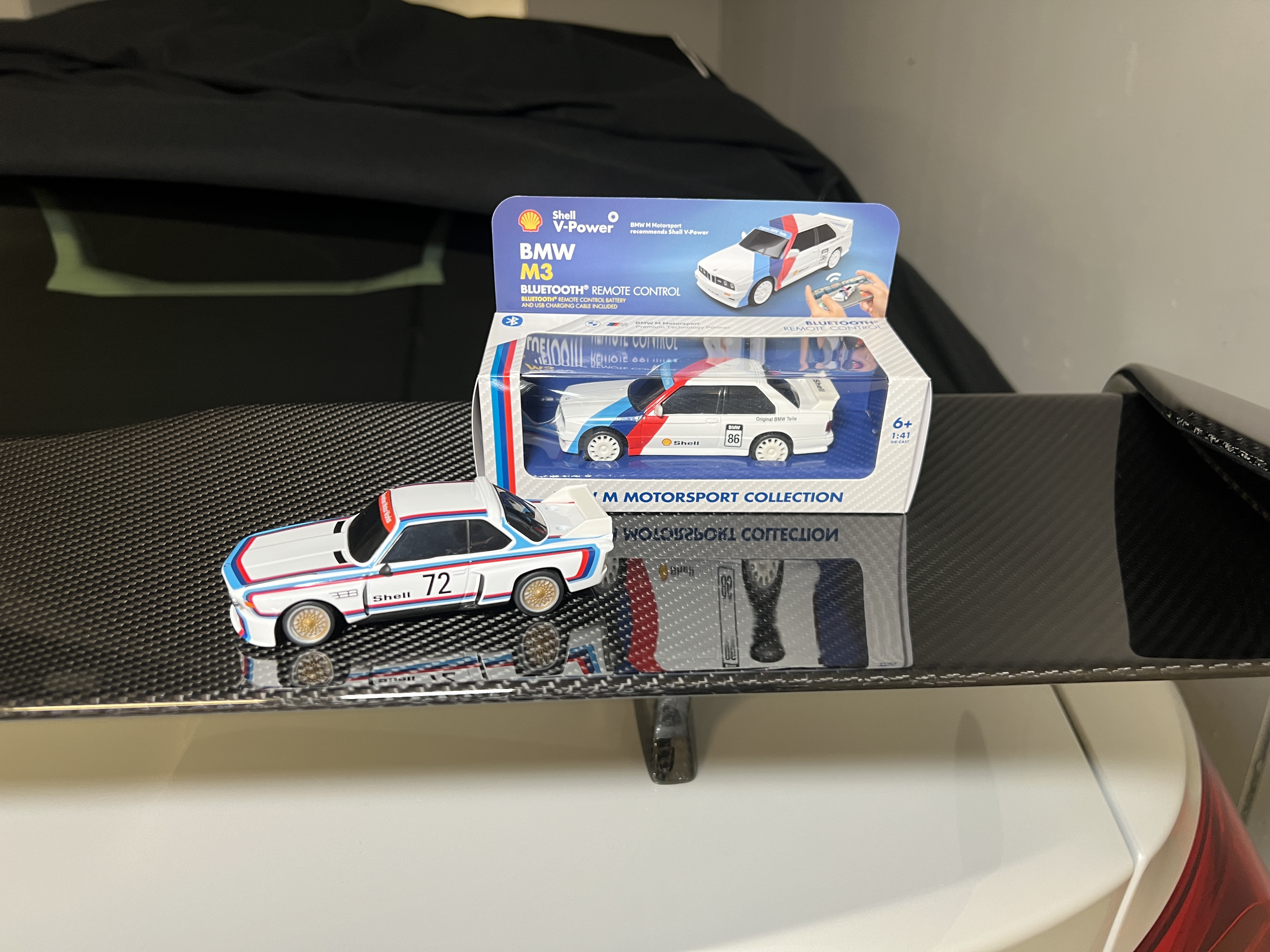 miniature car and box on spoiler