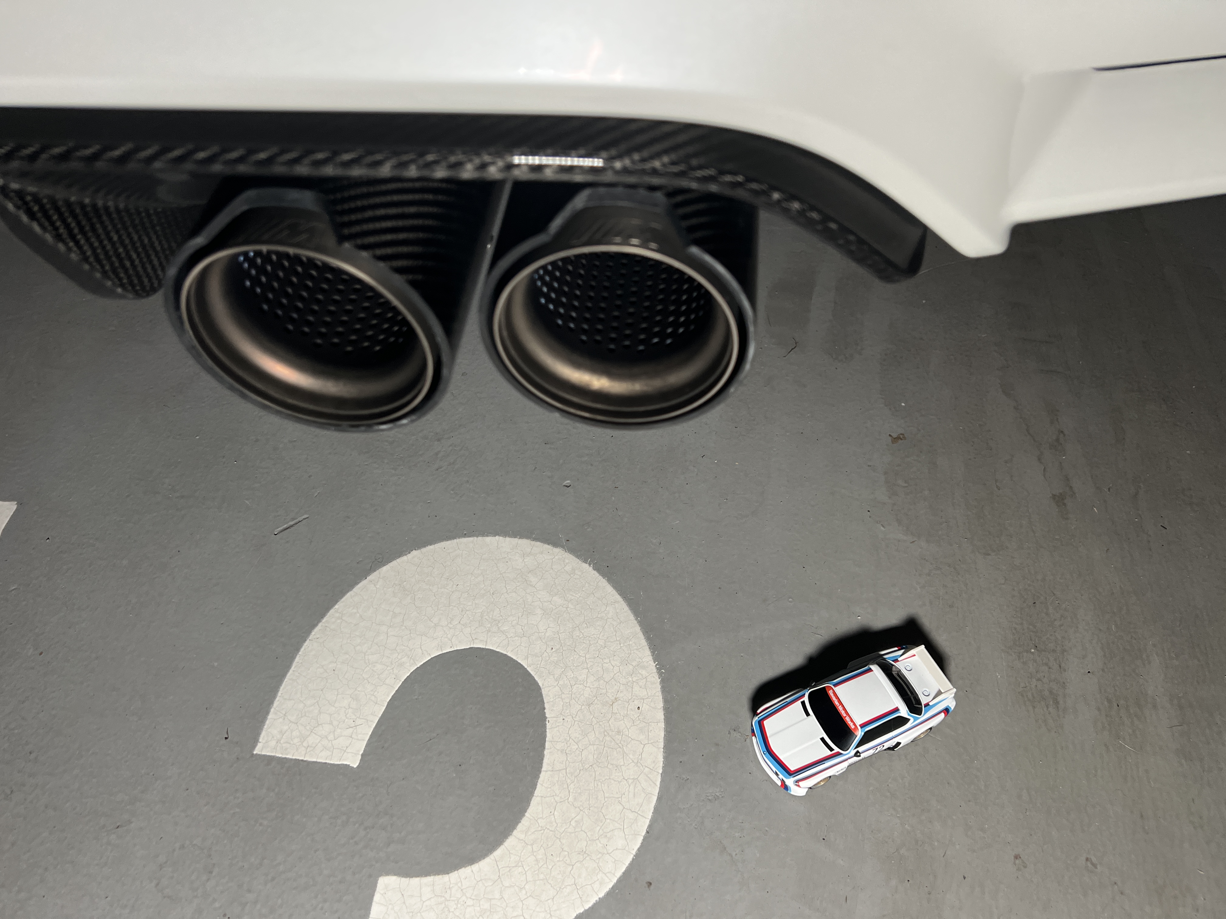 miniature car near exhaust pipes