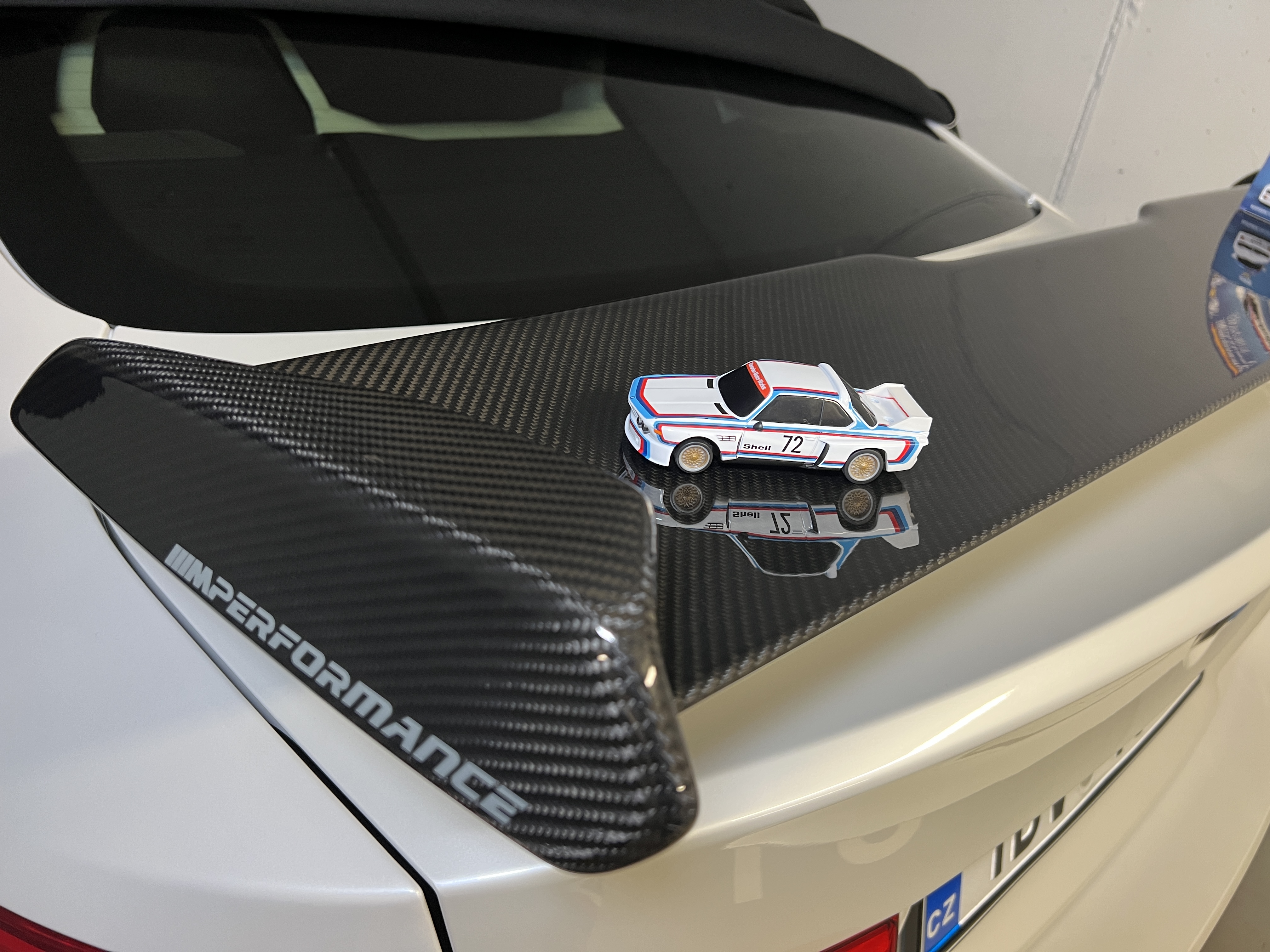 miniature car on carbon fiber spoiler
