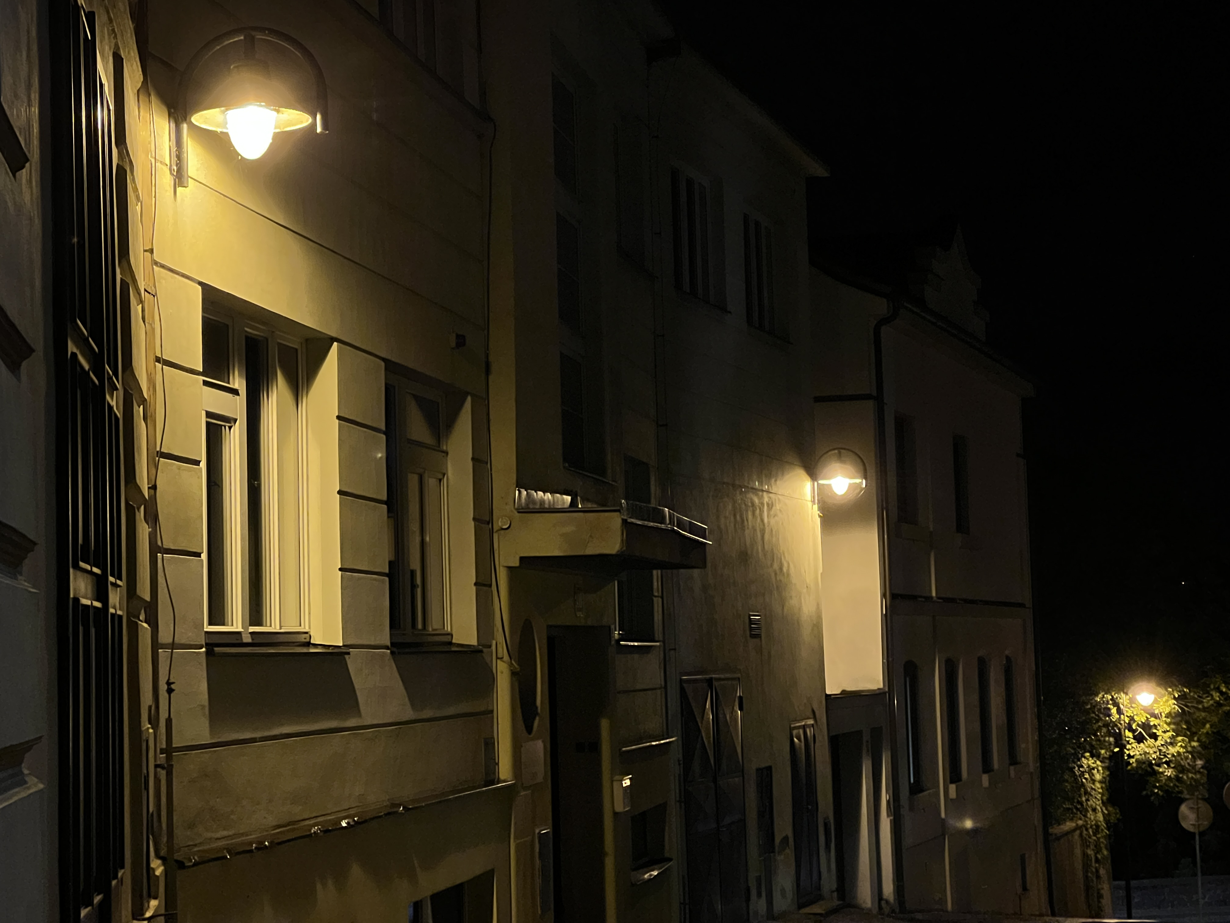 street lamps on narrow alley